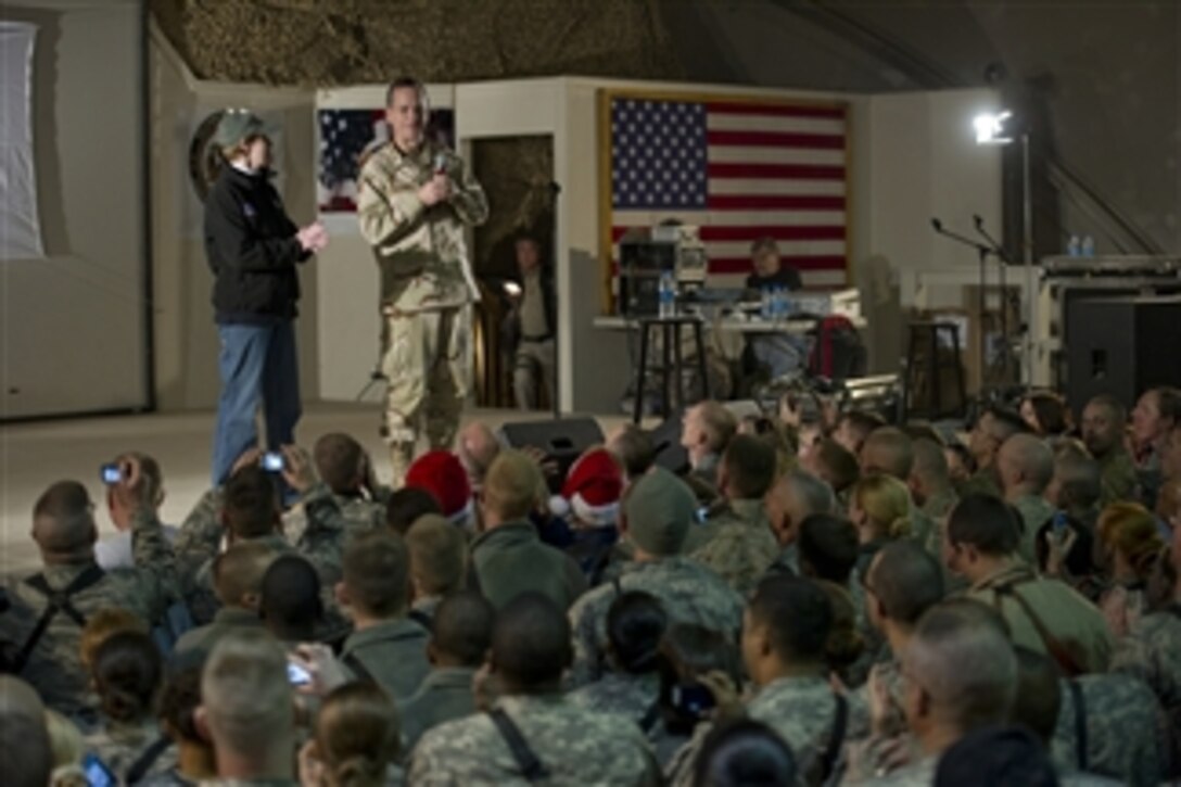 Chairman of the Joint Chiefs of Staff Adm. Mike Mullen, U.S. Navy, and his wife Deborah introduce the performers during the USO Holiday Show at Bagram Air Field, Afghanistan, on Dec.15, 2010.  The Mullens are hosting the tour featuring comedians Robin Williams, Lewis Black and Kathleen Madigan, Tour de France champion Lance Armstrong and country musicians Kix Brooks and Bob Dipiero touring the Central Command area of responsibility.  