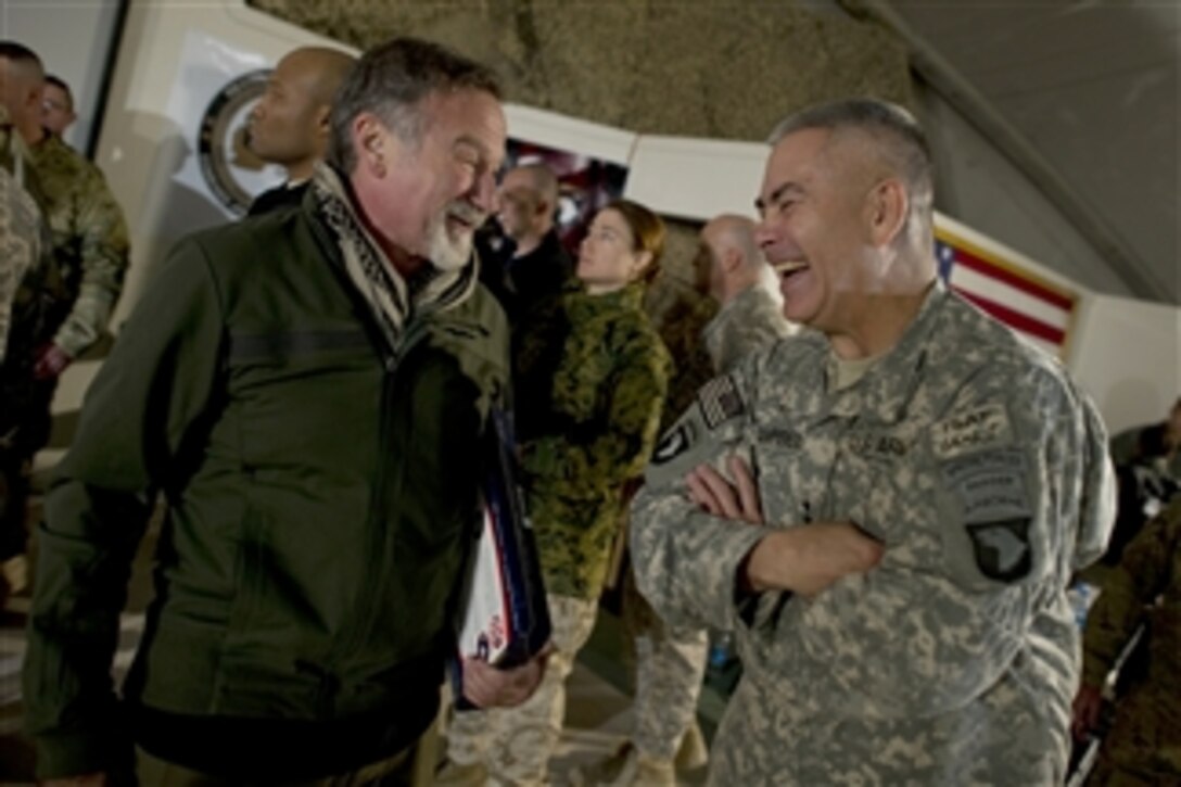 Comedian Robin Williams visits with Commanding General of Combined Task Force 101 U.S. Army Lt. Gen. John F. Campbell after the USO Holiday Tour show at Bagram Air Field, Afghanistan, on Dec.15, 2010.  Chairman of the Joint Chiefs of Staff Adm. Mike Mullen, U.S. Navy, and his wife Deborah are hosting the holiday tour featuring Williams and comedians Lewis Black and Kathleen Madigan, Tour de France champion Lance Armstrong and country musicians Kix Brooks and Bob Dipiero touring the Central Command area of responsibility.  