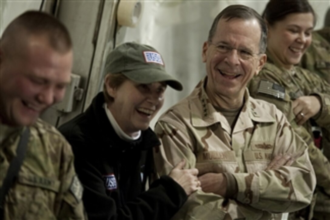 Chairman of the Joint Chiefs of Staff Adm. Mike Mullen, U.S. Navy, and his wife Deborah enjoy the USO Holiday Tour at Bagram Air Field, Afghanistan, on Dec.15, 2010.  The Mullens are hosting the holiday tour featuring comedians Robin Williams, Lewis Black and Kathleen Madigan, Tour de France champion Lance Armstrong and country musicians Kix Brooks and Bob Dipiero touring the Central Command area of responsibility.  