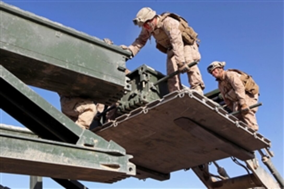 U.S. Marines use a forklift to help assemble bridge components during a bridge emplacement mission in the Sangin district of Afghanistan's Helmand province, Dec. 9, 2010. The Marines are assigned to the 8th Engineer Support Battalion, 1st Marine Logistics Group.