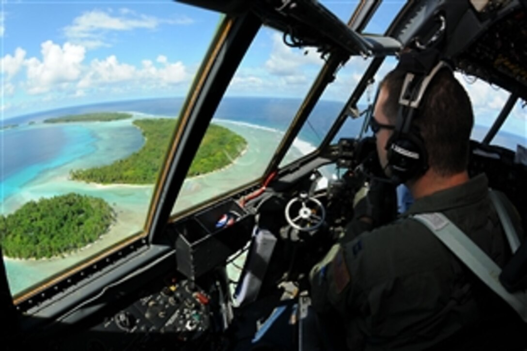 U.S. Air Force Capt. Phillip Newman looks out over the Yap Islands during Operation Christmas Drop, Dec. 14, 2010. Airmen assigned to the 36th Wing, Andersen Air Force Base, Guam, and the 36th Airlift Squadron, Yokota Air Base, Japan, each year to drop donated supplies over the Micronesian Islands. Newman is a C-130 Hercules pilot assigned to the 36th Airlift Squadron Yokota Air Base, Japan.