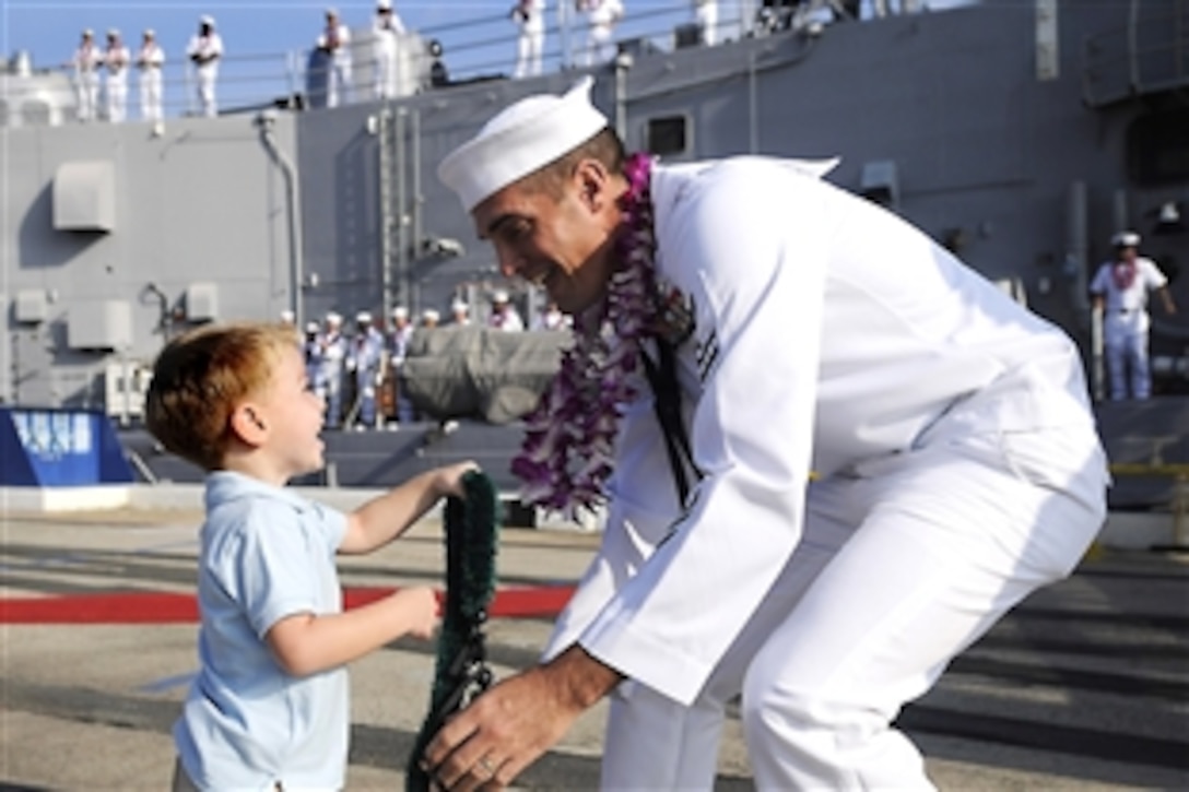 U.S. Navy Petty Officer 1st Class Frank Mortensen greets his son on the pier after returning to Joint Base Pearl Harbor-Hickam after a five-month deployment aboard the guided-missile frigate USS Crommelin, Dec. 14, 2010. While deployed, Crommelin participated in Cooperation Afloat Readiness and Training 2010 and Valiant Shield 2010 in the western Pacific Ocean. 