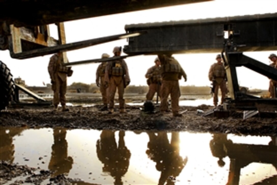 U.S. Marines use a forklift to assist in removing a bridge from the Helmand River in the Sangin District in Afghanistan's Helmand province, Dec. 7, 2010. The Marines, assigned to the 8th Engineer Support Battalion, 1st Marine Logistics Group, are conducting engineering operations for coalition forces and local residents to support the International Security Assistance Force.