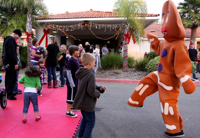Camp Pendleton children dance with the Gingerbread Man during the annual Winter Wonderland Festival at the Abby Reinke Center, Dec. 15. During the event, the guests were also able to take photos with Santa Claus and Rudolph the red-nose reindeer, enjoy free snacks, play games to win prizes, ride on the express train and get nutritional education while socializing.