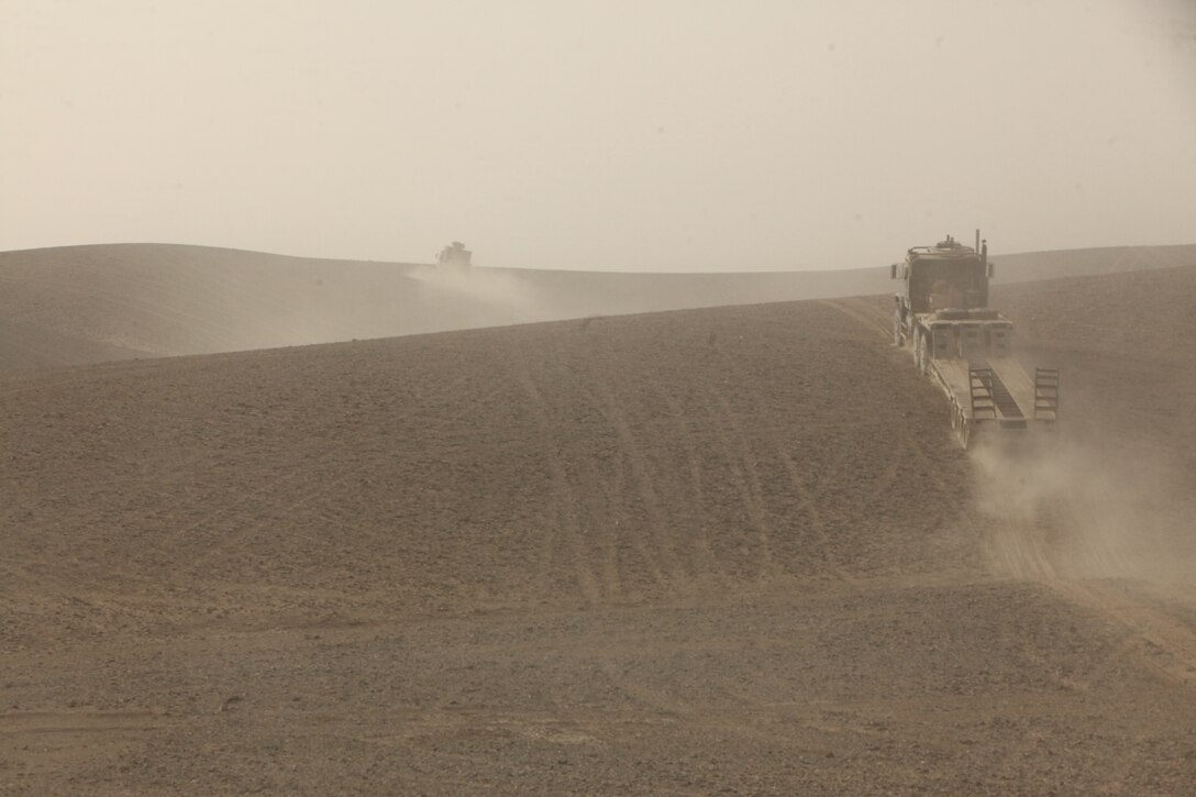 Marines from Service Company, 8th Engineer Support Battalion, 1st Marine Logistics Group (Forward), drive cross country during a combat logistics patrol to Camp Hansen in Helmand province, Afghanistan, Dec. 15. 8th ESB delivered mail along with other supplies to the Marines of 2nd Battalion, 9th Marine Regiment, 1st Marine Division