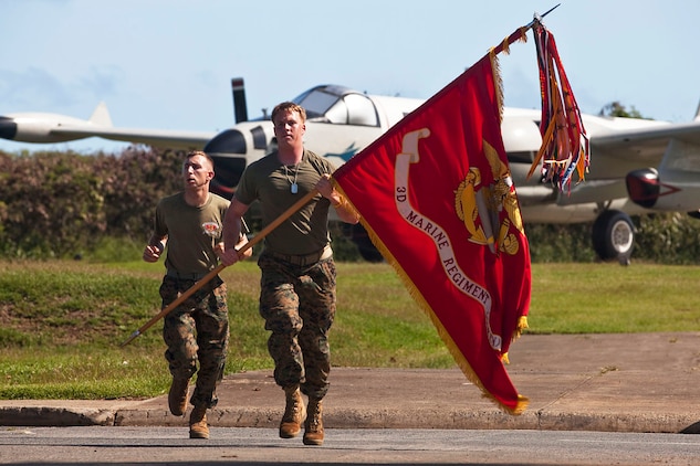Lance Cpls. Brian Donovan and Ryan Nygard, remain behind element, 2nd Battalion, 3rd Marine Regiment, run toward the Pacific War Memorial with the regimental battle colors during a Fallen Heroes Run on Marine Corps Base Hawaii, Dec. 15, 2010. Since 2004, 116 Marines and sailors from 3rd Marine Regiment have been killed during operations in Afghanistan and Iraq. On Dec. 14 and 15, teams of at least two Marines or sailors in combat boots and camouflage trousers ran a 2-mile evolution 116 times — one for each fallen hero. The route took them from the 3rd Marine Regiment headquarters building to the Pacific War Memorial here and back.