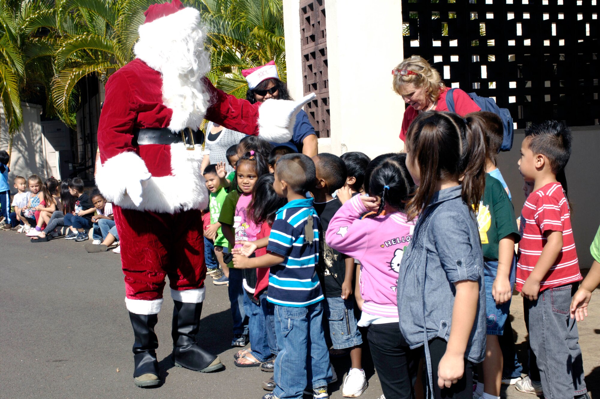 Children at the Oahu Head Start Program Holiday Party are visited by Santa Claus at the Makai Recreation Center at Joint Base Pearl Harbor-Hickam, Hawaii Dec. 16. A visit from Santa Claus, a magic show, and other activities highlighted the volunteer effort by base members to brighten the holiday spirit formore than 100 underpriviledged children. (U.S. Navy photo by David D. Underwood, Jr.)