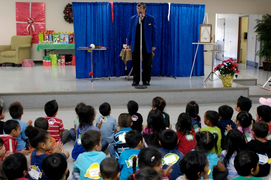 Mr. Glenn Bailey performs magic at the Oahu Head Start program holiday party at the Makai Recreation Center at Joint Base Pearl Harbor-Hickam, Hawaii Dec. 16. A visit from Santa Claus, a magic show, and other activities highlighted the volunteer effort by base members to brighten the holiday spirit formore than 100 underpriviledged children. (U.S. Navy photo by David D. Underwood, Jr.)