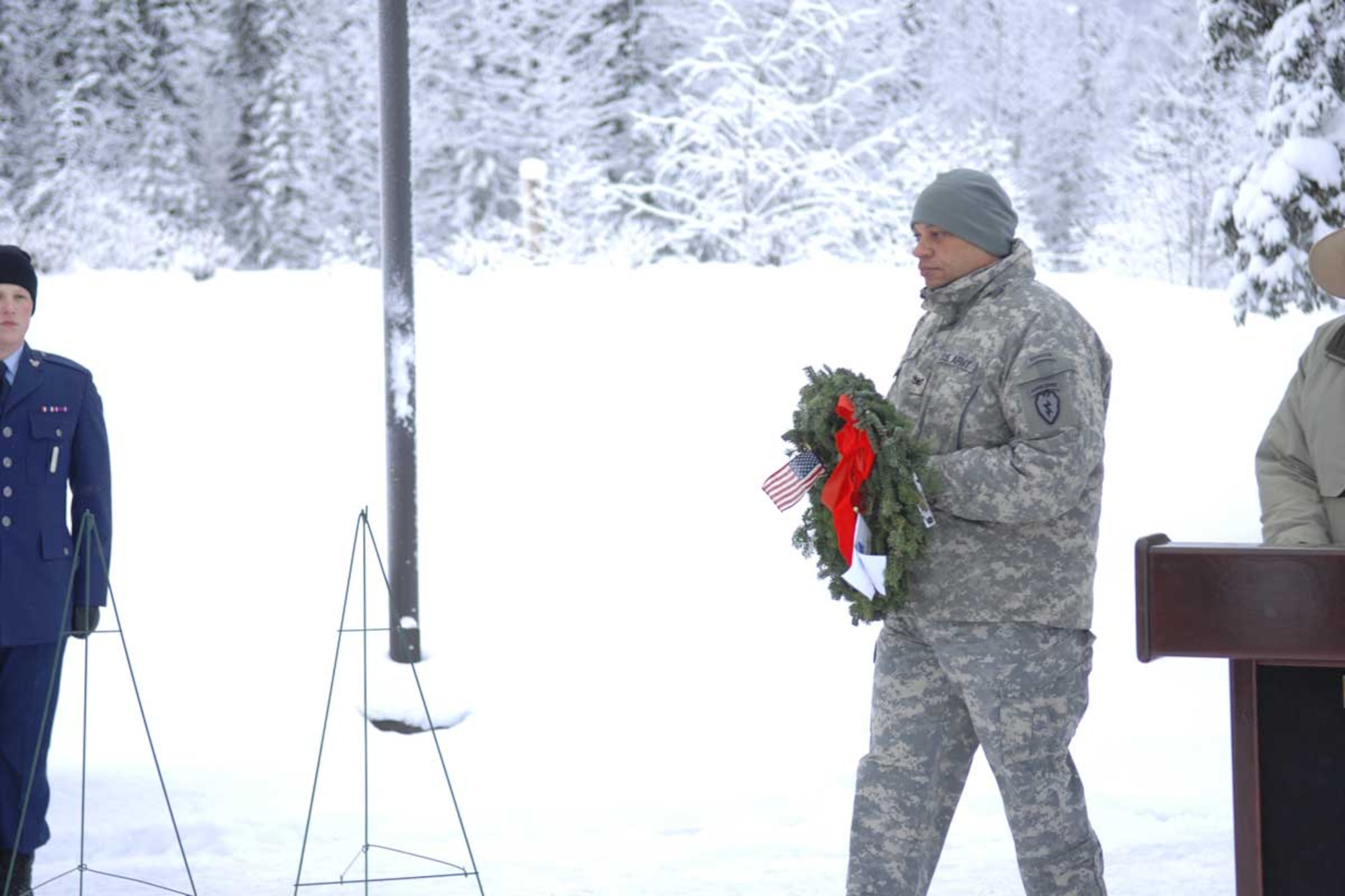 Army Col. Morris Goins, 4-25th ABCT commander, carries a wreath at Richardson National Cemetery, Saturday. (U.S. Army photo/SSgt. Mathew Winstead)