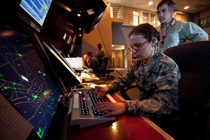 NELLIS AIR FORCE BASE, Nev. --  Airman 1st Class Kathryn Micldaugh and Mr. Sean Billet of the 57th Operation Support Squadron provides radar air traffic control to aircraft over the Nevada Test and Training Range from the Nellis Air Traffic Control Facility Dec., 14. The NATCF is responsible for providing radar service to local flying operations on the NTTR and Nellis. (U.S. Air Force photo by Tech. Sgt. Michael R. Holzworth)