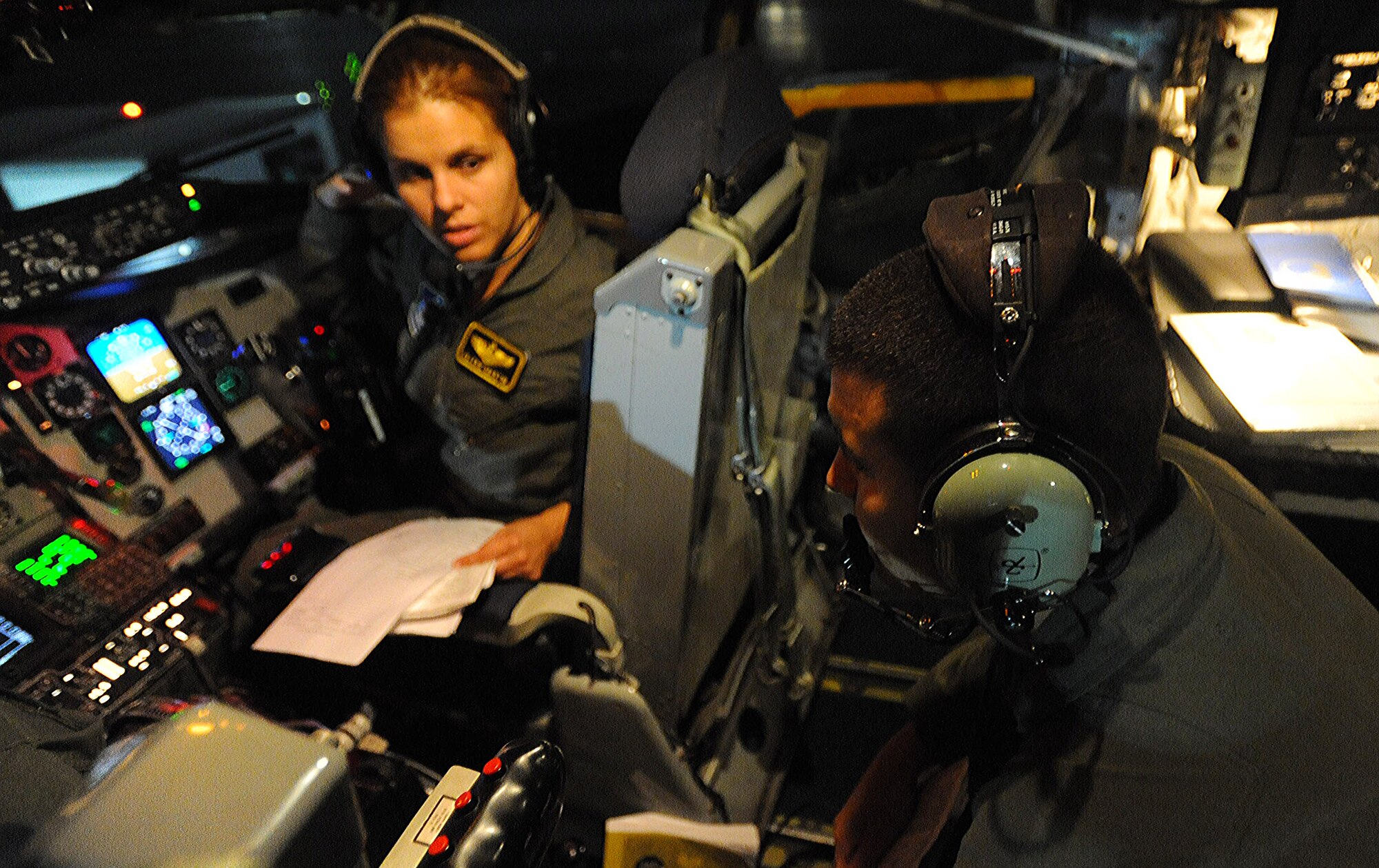 Maj. Valerie Martin and Capt. James Rorick, KC-135 pilots with the 96th Air Refueling Squadron, converse prior to the second sortie of the squadron's first operational refueling mission, Dec. 15 at Joint Base Pearl Harbor-Hickam, Hawaii. During the mission, a 96th ARS KC-135 Stratotanker joined a KC-135 from the Iowa Air National Guard as part of a two-ship formation to refuel two B-52 Stratofortresses on the way to Guam. (U.S. Air Force photo/Airman 1st Class Lauren Main)