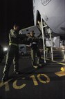 Master Sgt. Cohen Young (left), photojournalist with the Defense Media Activity, and Lt. Col. Eric Brumskilll, 96th Air Refueling Squadron KC-135 Stratotanker pilot, load gear into the aircraft for the second sortie of the squadron's first operational refueling mission, Dec. 15 at Joint Base Pearl Harbor-Hickam, Hawaii. During the mission, a 96th ARS KC-135 joined a KC-135 from the Iowa Air National Guard as part of a two-ship formation to refuel two B-52 Stratofortresses on the way to Guam. (U.S. Air Force photo/Airman 1st Class Lauren Main)