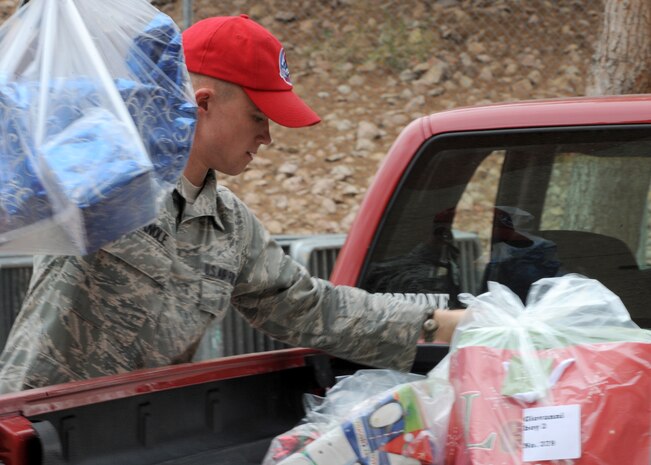 LAS VEGAS-- Senior Airman Nicholas Canole, an Angel Tree program volunteer from the 820th RED HORSE Squadron, unloads gifts for Clark County foster children at Cashman Field Dec. 15. The 820th donated $5,000 worth of gifts to the Clark County Court Appointed Special Advocates sponsored annual Angel Tree party.(U.S. Air Force photo by Airman 1st Class Matthew Lancaster)