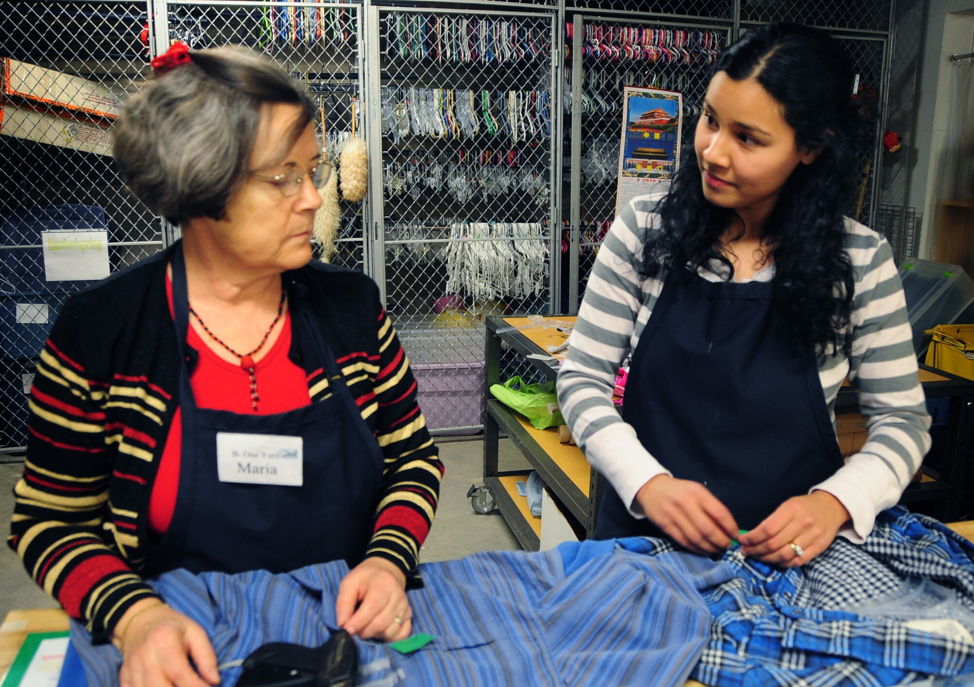 ELLSWORTH AIR FORCE BASE, S.D. -- (Left to right) Maria Gavle and Karen Loyde, volunteers working at the B-One Yard Thrift store, attach hangers and price tags to clothes, Dec. 16.  The thrift store offers Airmen E-4 and below a free ten dollar monthly allowance to purchase any items not under consignment. (U.S. Air Force photo/Senior Airman Anthony Sanchelli)
