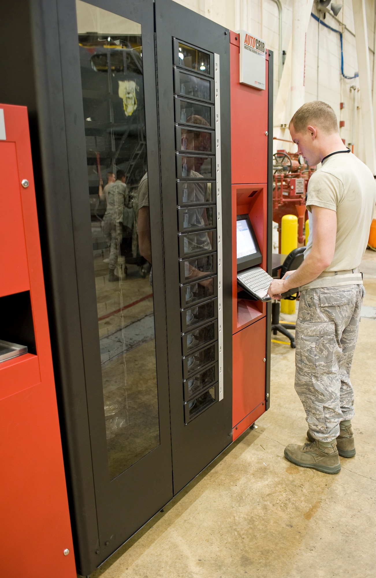 Senior Airman Bryant Fisher, 2nd Maintenance Squadron maintainer, logs into a bench stock vending machine in the phase hangar on Barksdale Air Force Base, La., Dec. 15. The machine streamlines the process of acquiring small parts such as bolts and washers for maintainers and eliminates the need to wait in line for each part. (U.S. Air Force photo/Senior Airman Chad Warren) (RELEASED)