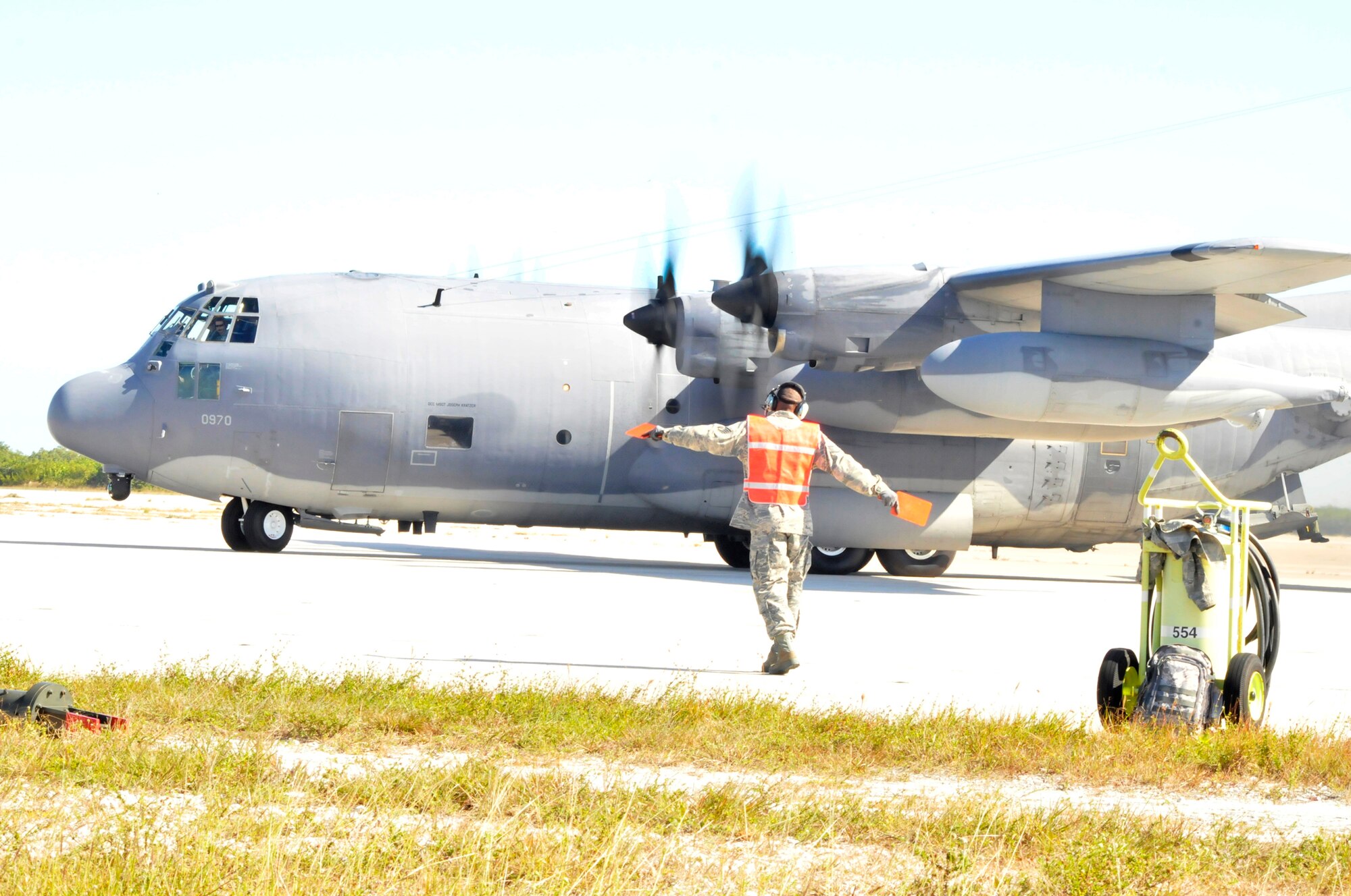 KEY WEST NAVAL AIR STATION, Fla. - Staff Sgt. Mark O'Neal, support section, 920th Maintenance Squadron, Patrick Air Force Base, Fla., directs the movement of an HC-130P/N King aircraft as aircrew personnel prepare to fly it for equipment and personnel drops during the Joint Key West Search and Rescue Exercise which 920th RQW Airmen participated in Dec. 8-13, 2010. (U.S. Air Force photo/Capt. Cathleen Snow)