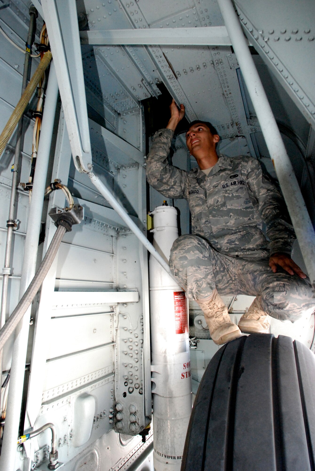KEY WEST, Fla. - Senior Airman Jerome Salgado, maintenance crew chief, HC-130P/N King, 920th Rescue Wing, Patrick Air Force Base, Fla., checks the wheel-well of the aircraft prior to take off. The maintenance crews worked long hours showing up hours before the pilots and crew to get the aircraft ready for take-off, and then stay long after the aircrews leave, to secure the planes. (U.S. Air Force photo/Staff Sgt. Leslie Kraushaar)