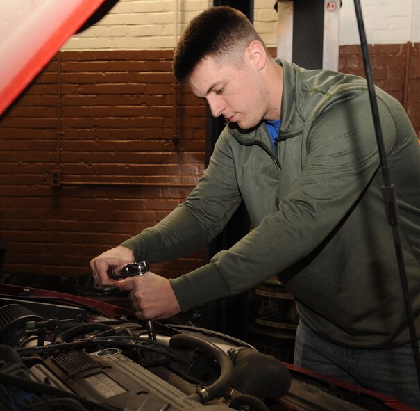 Senior Airman Charles Scholle, 2nd Communications Squadron, works on his car at the Auto Hobby Shop on Barksdale Air Force Base, La., Dec. 16. The shop provides a place where Airmen can save money, learn, and perform maintenance on their automobiles. The new hobby shop and car wash broke ground this month and the old shop will be refurbished to accommodate a contracted motorcycle maintenance shop. (U.S. Air Force photo/Airman 1st Class Sean Martin)(Released)