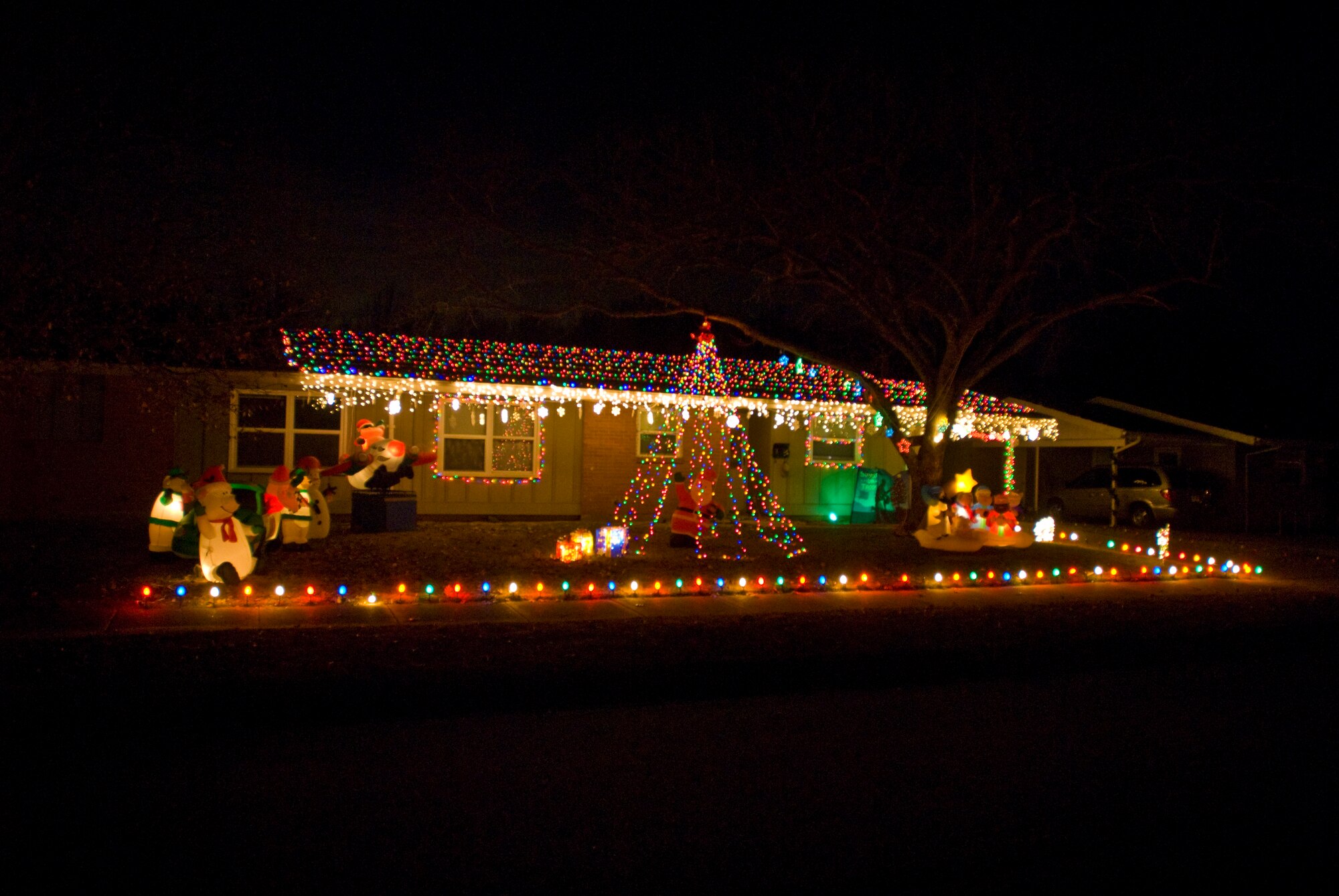 Holiday lights and decorations light up base housing’s Meadow Wood Estates neighborhood Dec. 14, 2010, at Little Rock Air Force Base, Ark. Army Staff Sgt. John Schwarz, assigned to Camp Robinson, won the annual holiday lighting contest with a mix of twinkling lights and whimsical inflatable characters. The three-year resident, who won the lighting contest two years in a row, said the entire project took approximately four hours to set up. (U.S. Air Force photo by Staff Sgt. Nestor Cruz)