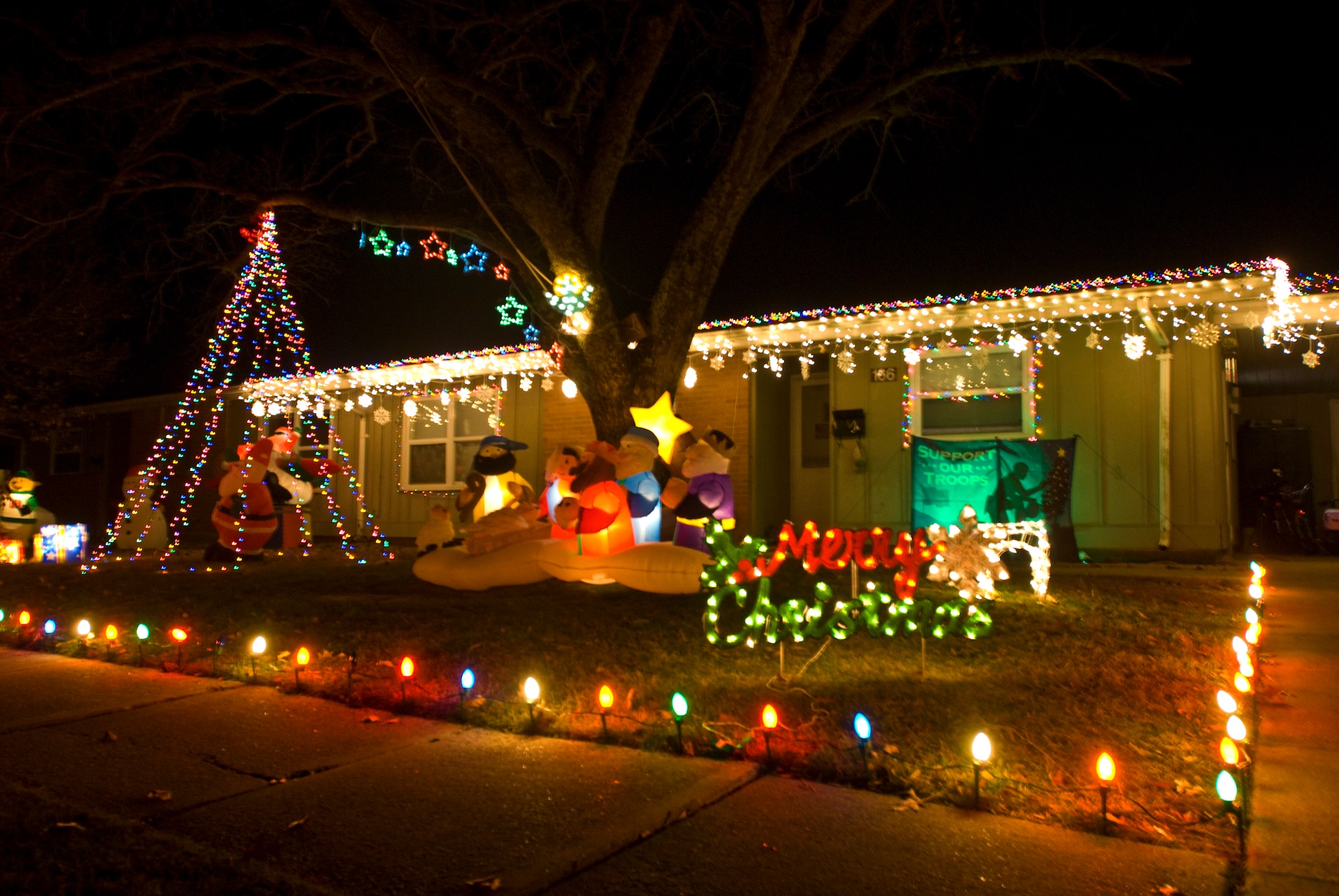 Holiday lights and decorations light up base housing’s Meadow Wood Estates neighborhood Dec. 14, 2010, at Little Rock Air Force Base, Ark. Army Staff Sgt. John Schwarz, assigned to Camp Robinson, won the annual holiday lighting contest with a mix of twinkling lights and whimsical inflatable characters. The three-year resident, who won the lighting contest two years in a row, said the entire project took approximately four hours to set up. (U.S. Air Force photo by Staff Sgt. Nestor Cruz)