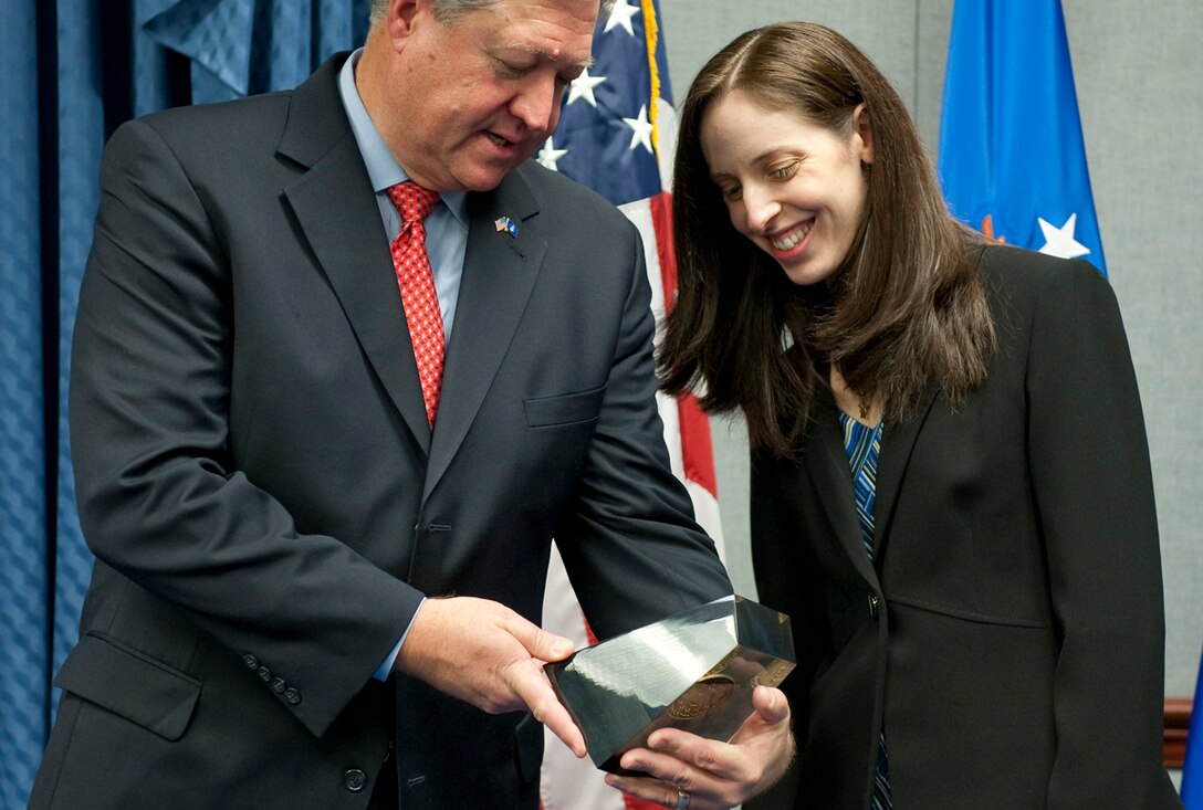 Secretary of the Air Force Michael Donley (left) presents the 2010 Harold Brown Award to Dr. Candace Lynch (right) during a ceremony in the Pentagon on Dec. 15, 2010. The award was named after Harold Brown who served as Secretary of the Air Force from 1965-1969. Dr. Lynch is the first female recipient of the award since its inception in 1969. (U.S. Air Force photo/Jim Varhegyi)