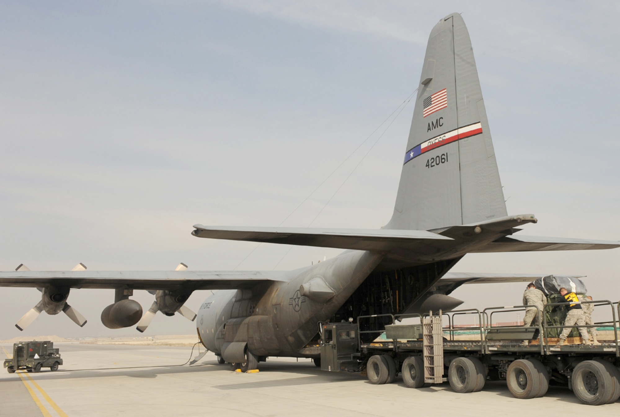 Airmen and Soldiers help load container delivery system bundles into the back of a C-130 Hercules recently at Bagram Air Field, Afghanistan. A crew from the wing's 737th Expeditionary Airlift Squadron flew an airdrop mission in Afghanistan and dropped more than 22,000 pounds of supplies to ground troops Nov. 21, 2010, validating the wing's ability to perform airdrop missions in support of Operation Enduring Freedom. (U.S. Air Force photo/Lt. Col. Ken Gjone)