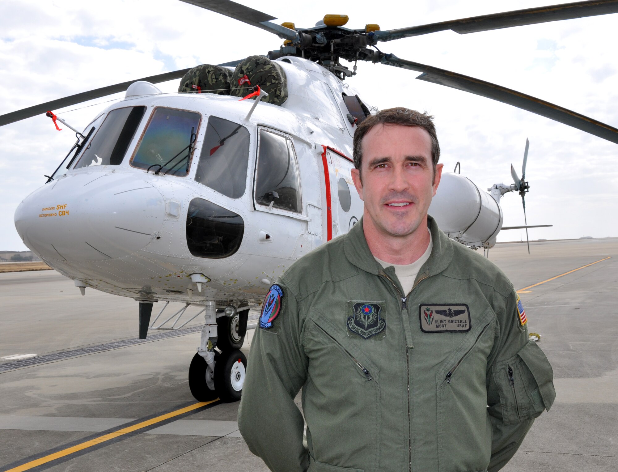 Master Sgt. Clint Grizzell, 6th Special Operations Squadron operations superintendent and combat aviation advisor, poses in front of an Mi-17 helicopter at the flightline at Hurlburt Field, Fla., Dec. 16, 2010. Sergeant Grizzell was selected for this week's "Tip of the Spear" spotlight. (DoD photo by U.S. Air Force Airman 1st Class Joe McFadden / RELEASED) 
