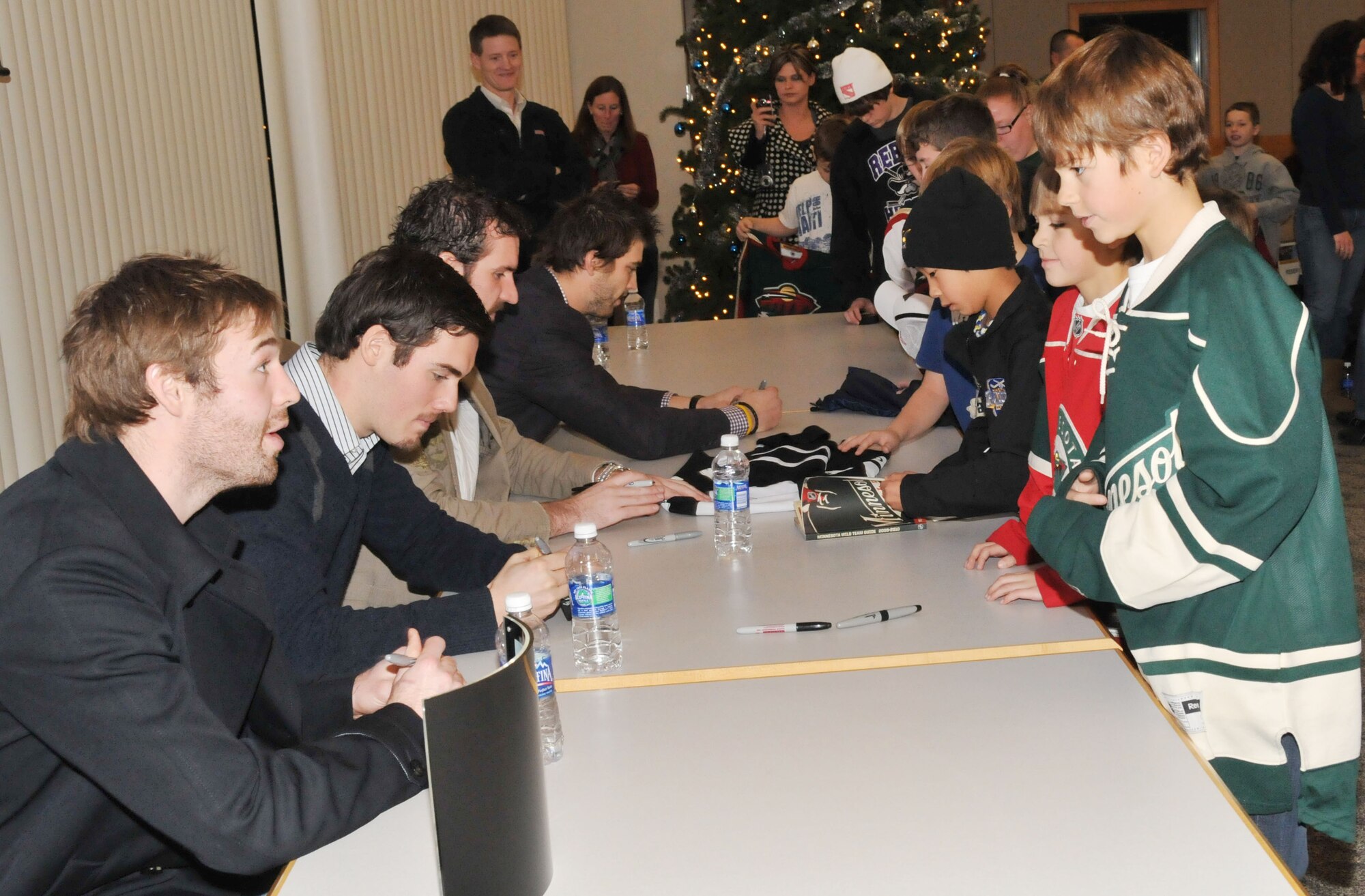 Members of the Minnesota Wild sign autographs for children of military families Dec. 15. (Air Force Photo/Paul Zadach)