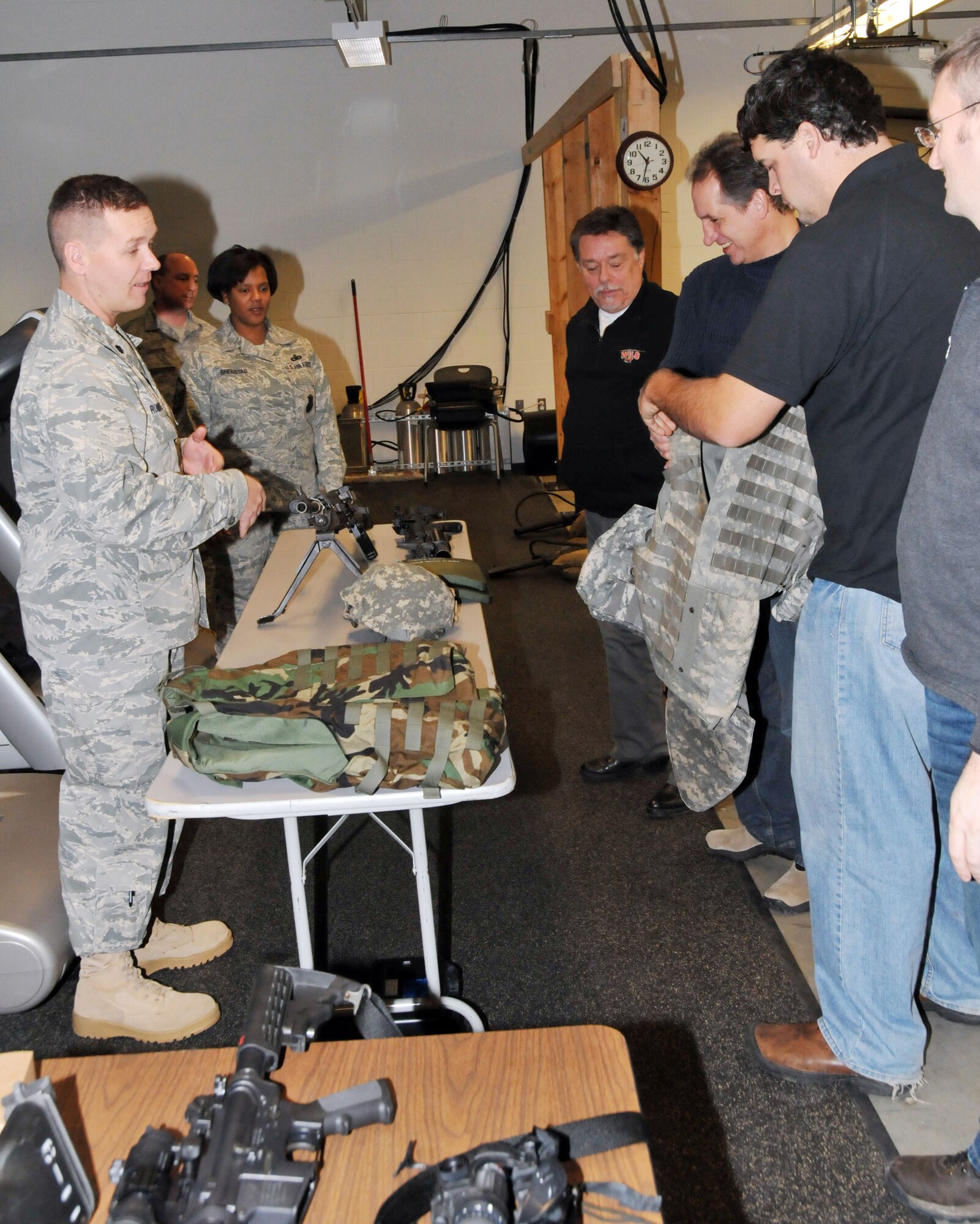 Lt. Col. Ted Ruminski, 934th Security Forces Squadron commander, explains Air Force munitions to Members of the Minnesota Wild, Defending the Blue Line and National Hockey League Players Association during their tour of the 934th Security Forces Squadron Dec. 16. (Air Force Photo/Paul Zadach)