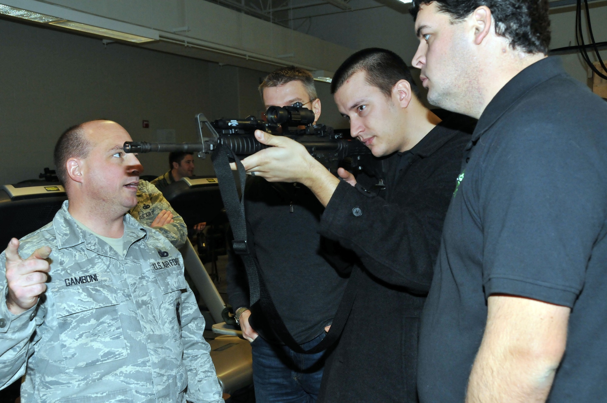 Master Sgt. Anthony Gamboni, 934th Security Forces Squadron, explains Air Force munitions to Members of the Minnesota Wild, Defending the Blue Line and National Hockey League Players Association during their tour of the 934th Security Forces Squadron Dec. 16. (Air Force Photo/Paul Zadach)