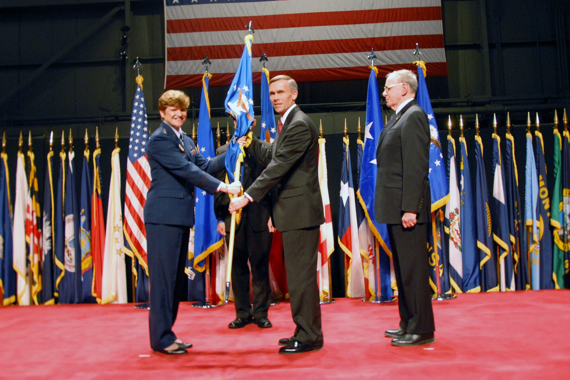 DAYTON, Ohio -- Lt. Gen. (Ret.) John "Jack" L. Hudson (center) became director of the National Museum of the U.S. Air Force during a ceremony on Dec. 16, 2010. Lt. Gen. Janet C. Wolfenbarger (left), vice commander of Air Force Materiel Command, presided over the change of director ceremony. Hudson took the reins from Maj. Gen. (Ret.) Charles D. Metcalf (right) , who is retiring after serving 14 years as museum director. (U.S. Air Force photo by Jeff Fisher)