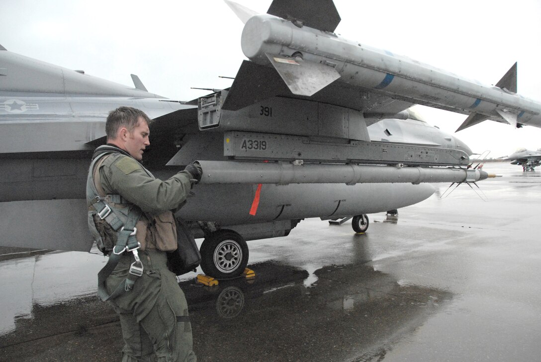 Capt. Matt Hepp conducts a preflight inspection of his F-16 Fighting Falcon at Komatsu Japanese Air Self-Defense Force Base Dec. 7, 2010, before a mission over the Sea of Japan.  More than 160 Airmen from Misawa Air Base, Japan, are deployed to Komatsu from Dec. 3 to 11 in support of Exercise Keen Sword 2011. Captain Hepp is a pilot with the 14th Fighter Squadron. (U.S. Air Force photo/1st Lt. Cammie Quinn)