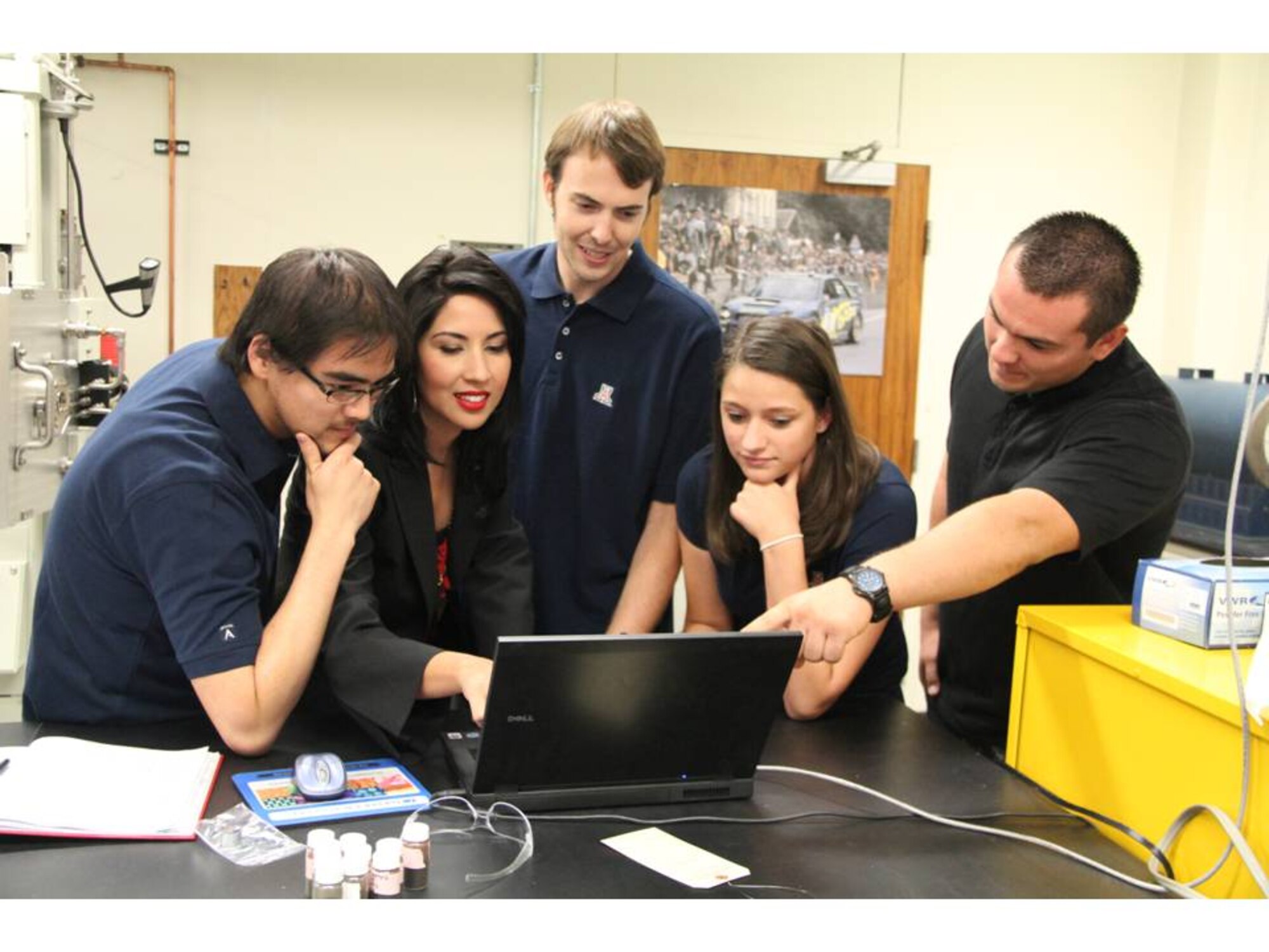 University of Arizona Professor Erica L. Corral (second from left) with her undergraduate and graduate research assistants review research findings in the high-temperature ceramics lab. The UA students shown from left to right are Doctoral candidates David Pham and Luke S. Walker and undergraduate research assistants Victoria Marotto and Mario Valdez. Air Force Office of Scientific Research is supporting the effort for future hypersonic aerospace applications. (Courtesy photo/Pete Brown, University of Arizona)