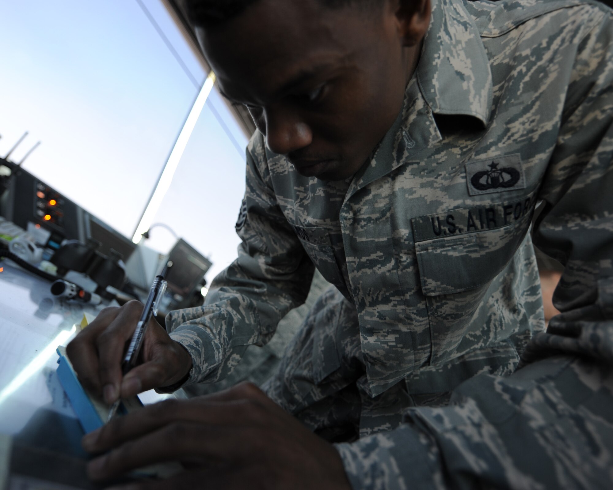 Staff Sgt. Tyrone Edwards, an air traffic controller deployed from Keesler, documents arrival and departure times on a flight progress strip at an undisclosed location in Southwest Asia, Oct. 18. Up to 282 Dragons have been deployed each week during 2010 from units across Keesler.  (U.S. Air Force photo by Senior Airman Katie Gieratz)
