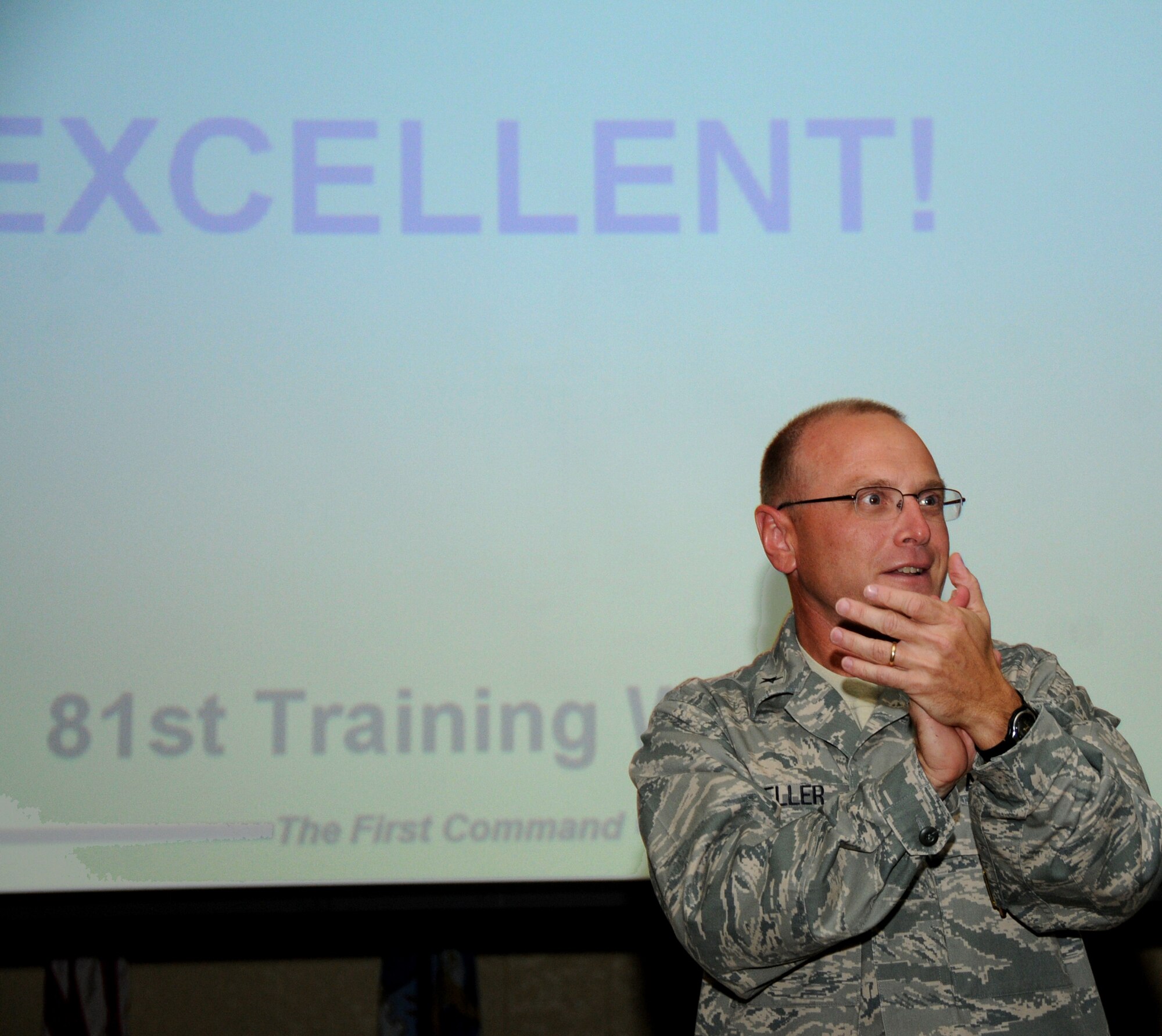 Brig. Gen. Andrew Mueller, 81st Training Wing commander, shows his pride in Team Keesler during an outbrief in which the base learned of its “Excellent” rating from the Air Education and Training Command Inspector General Compliance Inspection, Oct. 24-Nov. 2.  (U.S. Air Force photo by Kemberly Groue)