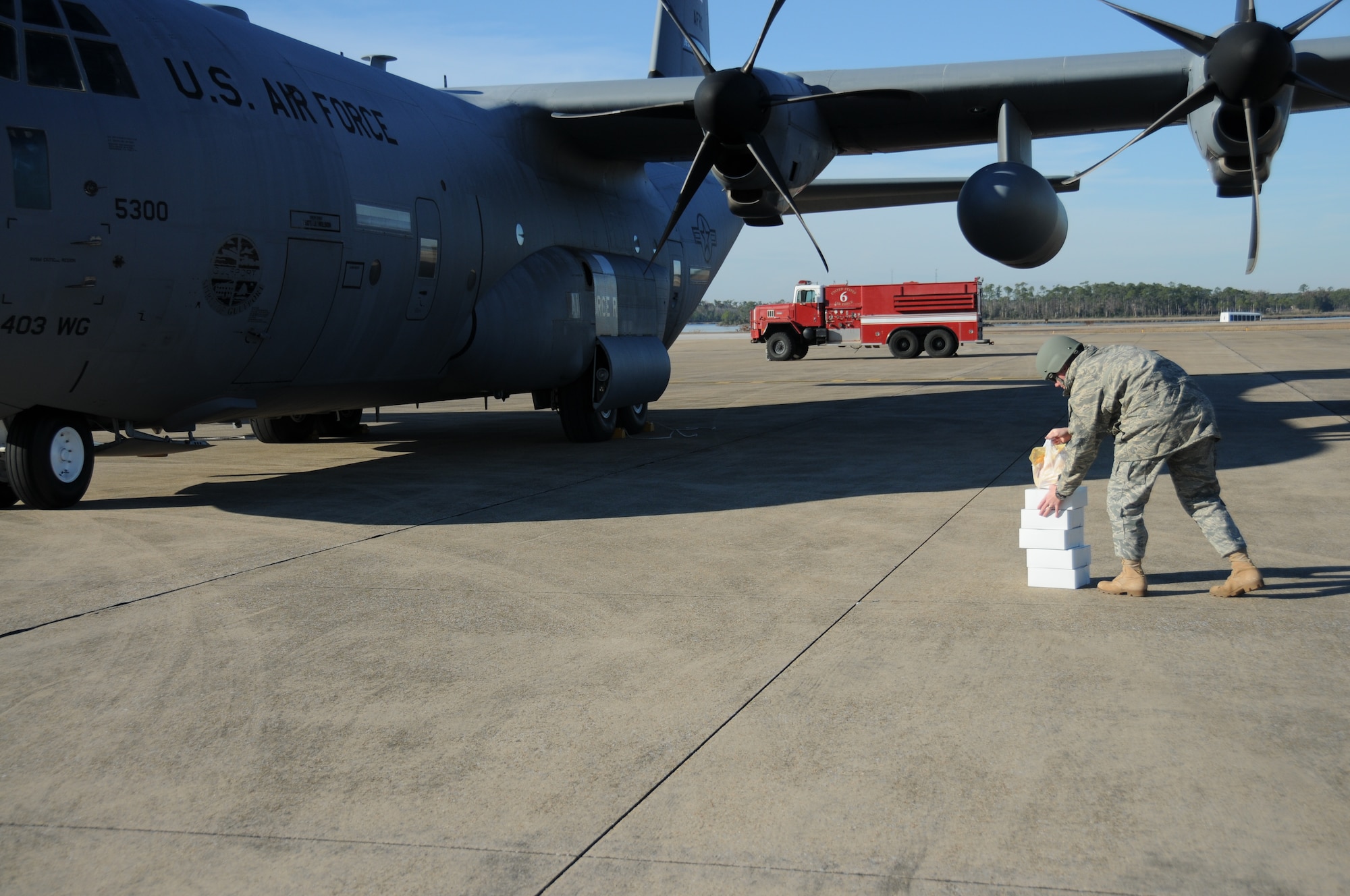 Sergeant Bowling delivers food demanded by the hijacker to the aircraft.  (U.S. Air Force photo by Kemberly Groue)