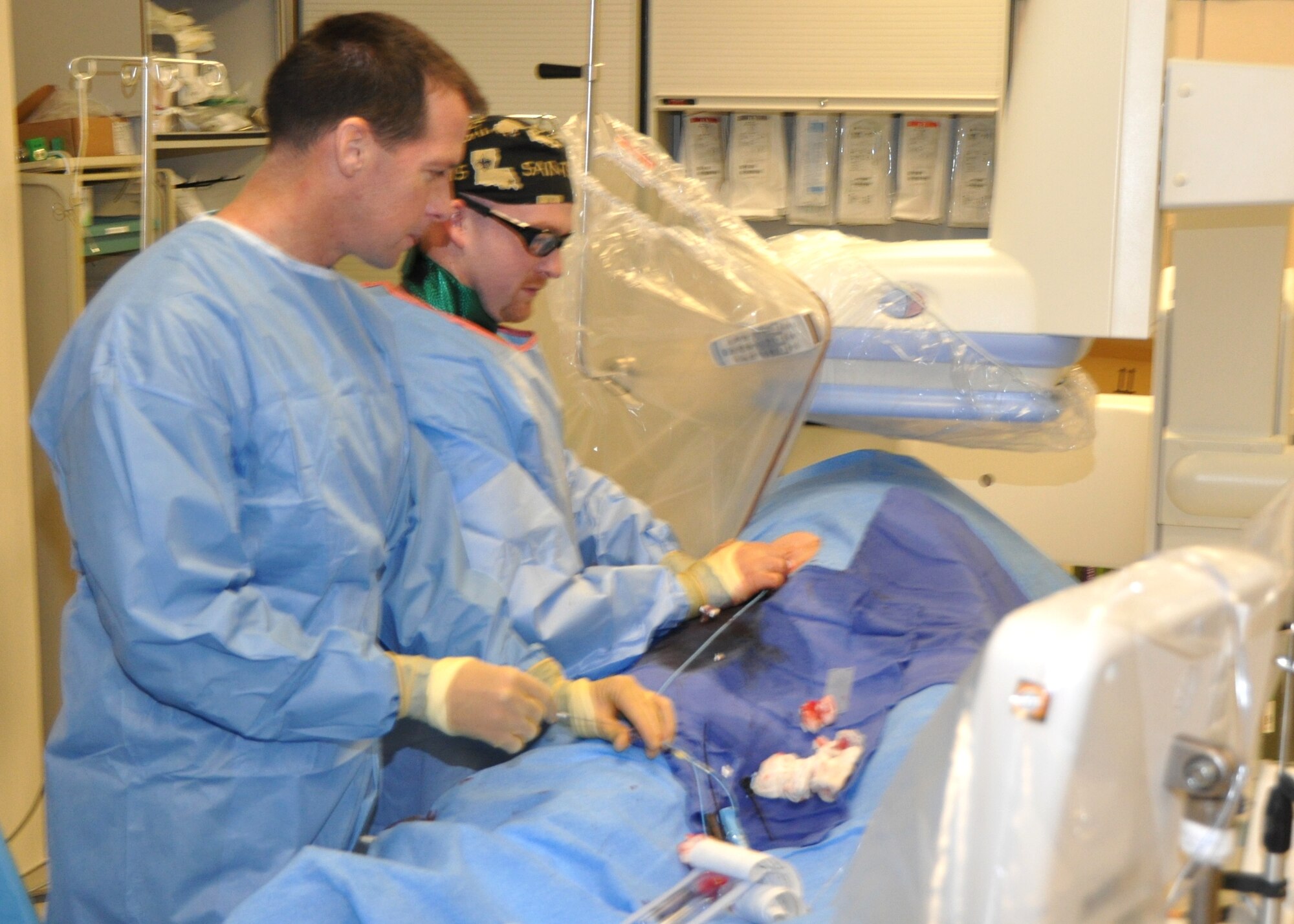Dr. Kindsvater, left, and Mr. Hudson perform a heart catheterization
Tuesday.  (U.S. Air Force photo by Steve Pivnick)