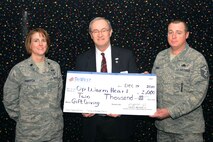 MINOT AIR FORCE BASE, N.D. -- Lt. Col. Tasha Pravecek, 5th Medical Support Squadron commander, Don Jenn, TriWest Healthcare Alliance Service Area director, and Master Sgt. Kevin Denny, 5th Security Forces Squadron first sergeant and First Sergeant’s Council president, accept a check for $2,000 donated to Operation Warmheart here Dec. 15. Operation Warmheart is geared toward helping Airmen and their families who face financial hardships and emergencies; providing them with grants to support them in their time of need. (U.S. Air Force photo/Airman 1st Class Aaron-Forrest Wainwright)