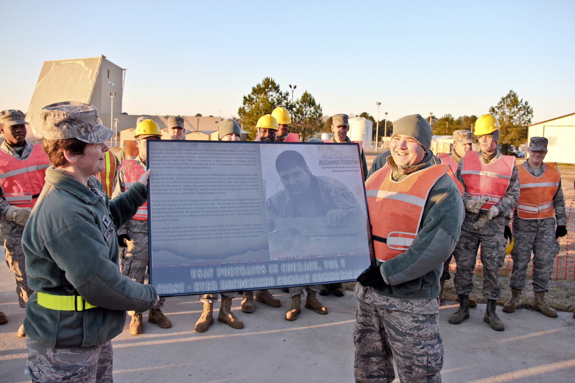 Col. Theresa Giorlando surprises Staff Sgt. Alexander Yessayan with a plaque Dec. 6, 2010, at Robins Air Force Base, Ga. The plaque includes the pages dedicated to him for being included in the "Portraits in Courage" series. Sergeant Yessayan became the first combat communications Airman and first member of 24th Air Force to be recognized in the series Dec. 10, 2010. Colonel Giorlando is the  689th Combat Communications Wing commander and Sergeant Yessayan is assigned to the 53rd Combat Communications Squadron. (U.S. Air Force photo/2nd Lt. Joel Cooke)