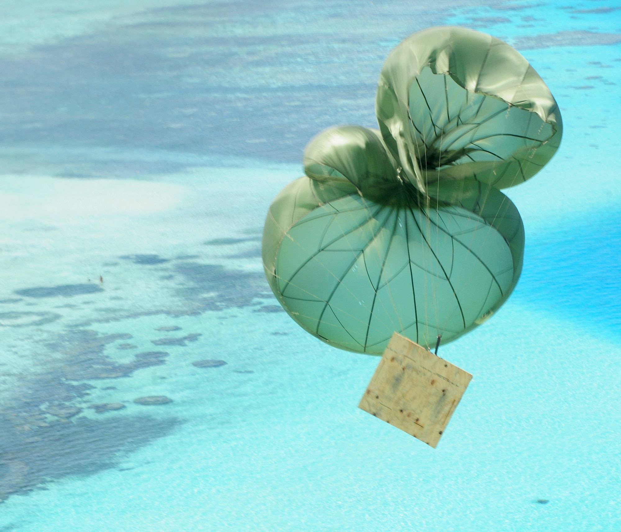 A box of humanitarian goods floats to the drop zone during Operation Christmas Drop Dec. 14, 2010, over the Yap Islands, Commonwealth of the Northern Marianas Islands. Operation Christmas Drop began in 1952 and is the Air Force’s longest-running humanitarian operation. (U.S. Air Force photo/Senior Airman Nichelle Anderson)