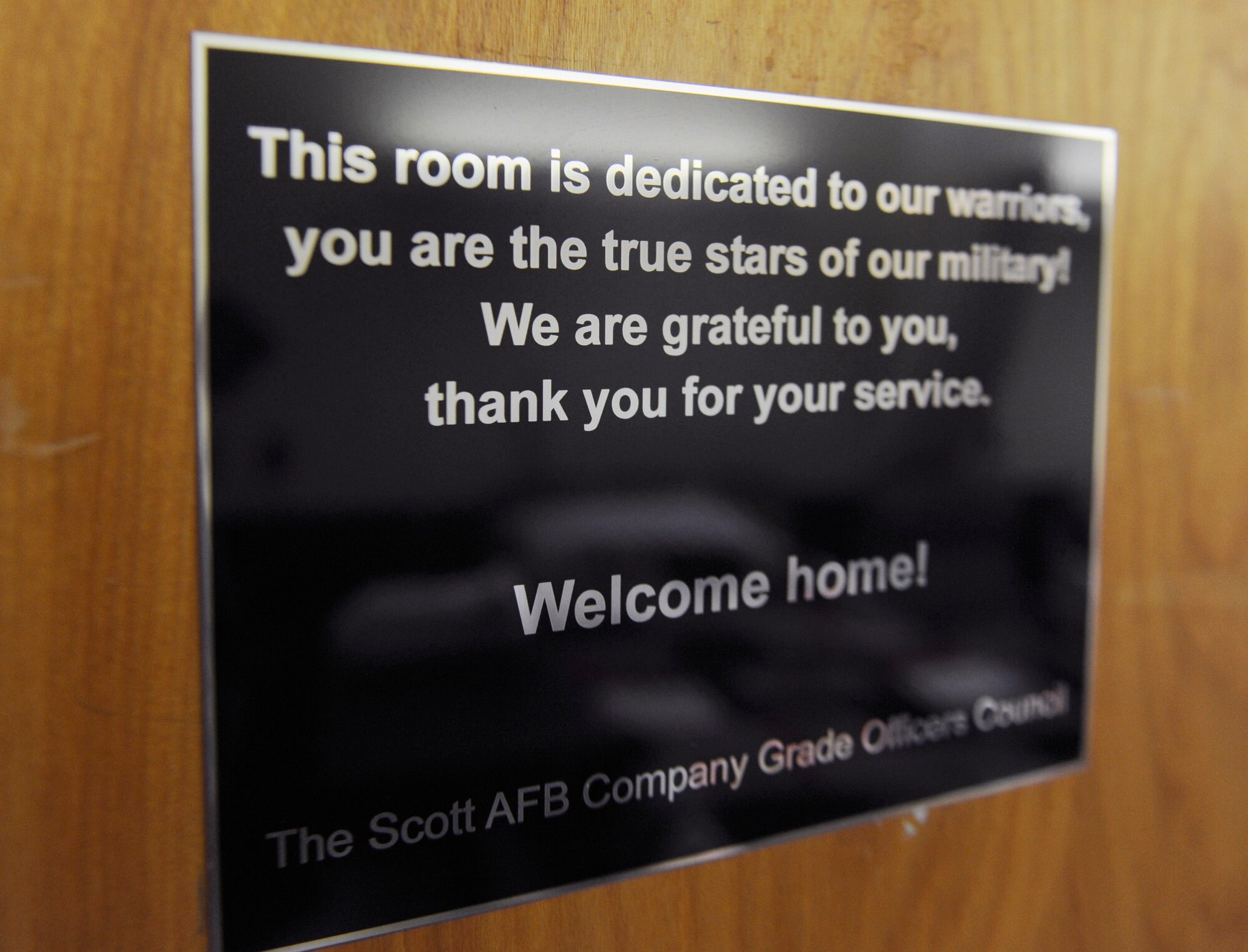 A placard displayed on a patient's room at the 375th Aeromedical Staging Flight denotes that the room is sponsored by the Company Grade Officer Council Dec. 13, 2010, at Scott Air Force Base, Ill. This room is one of 17 patient rooms and nine common areas sponsored by various agencies around the base. (U.S. Air Force photo/ Staff Sgt. Ryan Crane)
