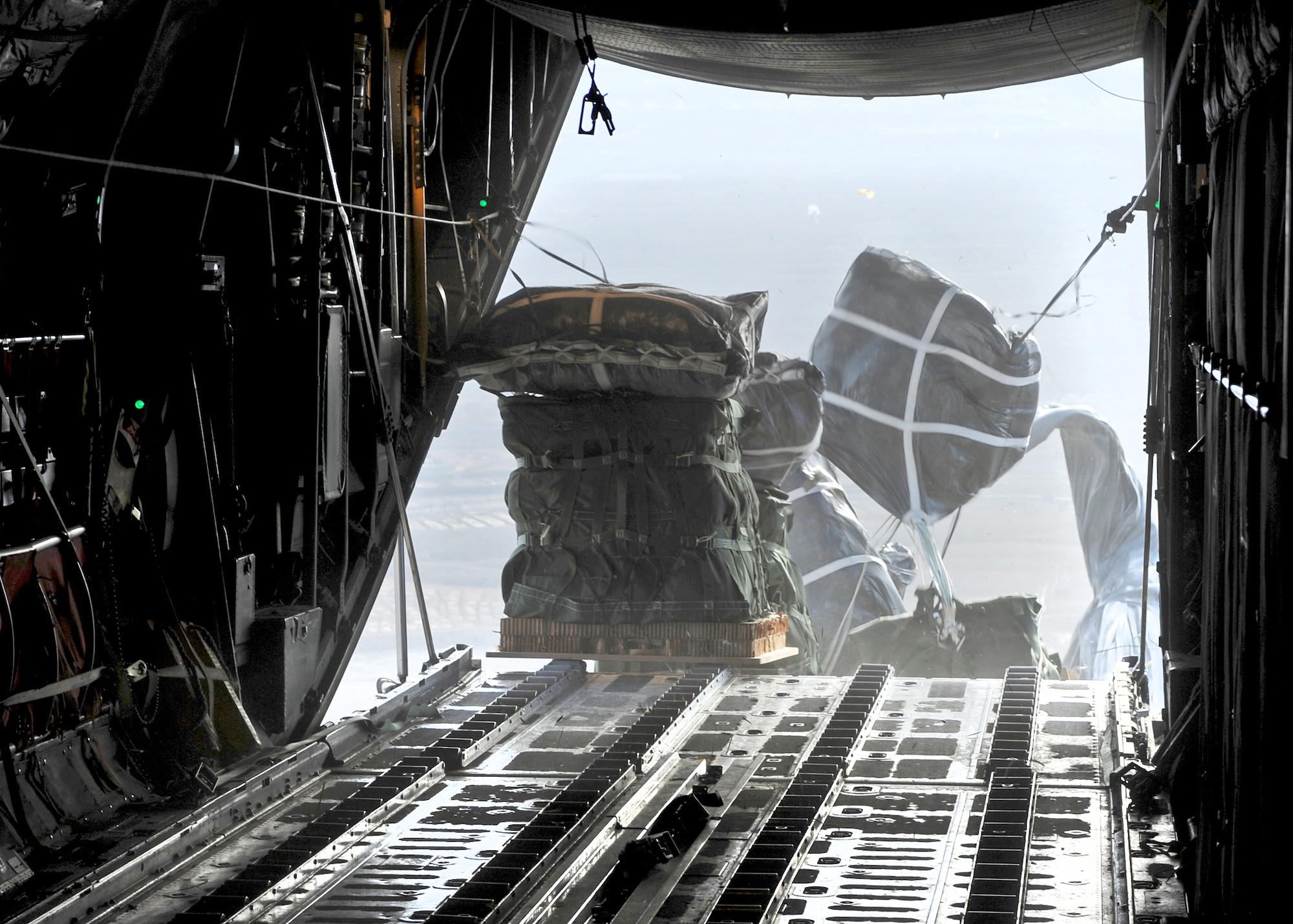 Supplies are dropped to ground forces in Afghanistan from the back of a C-130 Hercules Nov. 21, 2010, during a mission performed by the 737th Expeditionary Airlift Squadron. The event validated the unit's ability to perform airdrop missions in support of Operation Enduring Freedom. (U.S. Air Force photo/Lt. Col. Ken Gjone)
