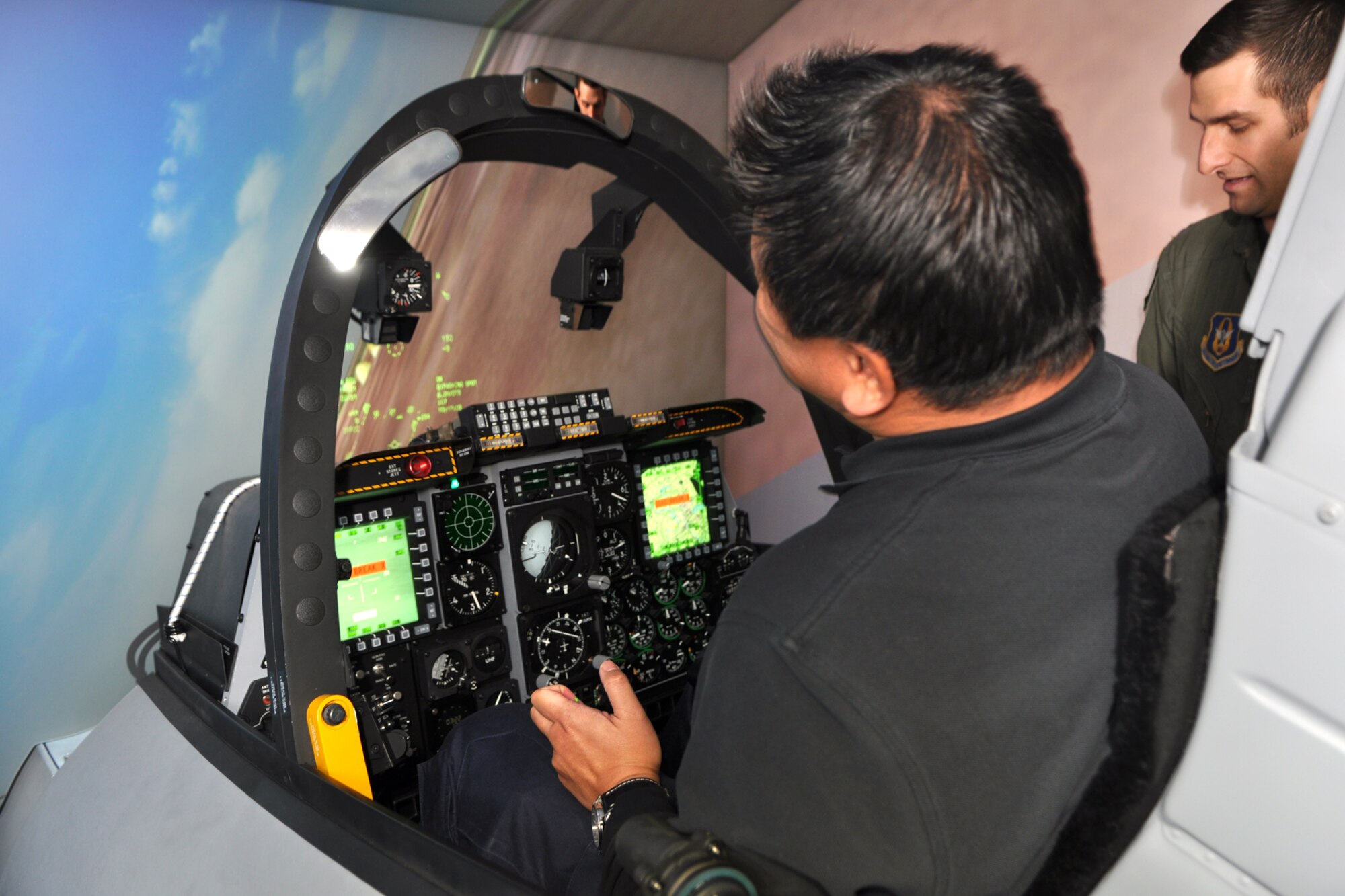Jack Sykes, art director, Professional Pilot magazine, proves you can perform a “crash and burn” scenario in an A-10 simulator, as he inadvertently rolls his jet into the ground during a familiarization session at Barksdale Air Force Base, La., Dec. 10, 2010. Mr. Sykes, under the professional tutelage of Capt. Grant McCall, standardization and evaluations liaison officer, 47th Fighter Squadron, recovered from his death defying act of courage and went on to down a bogie during his visit to the 47th FS, bringing his final results to one won and one lost. Mr. Sykes was at Barksdale gathering information and taking photos for a story about the professional pilots of the 917th Wing for an upcoming issue of the Professional Pilot magazine to be published in early 2011. (U.S. Air Force photo/Tech. Sgt. Jeff Walston) 
