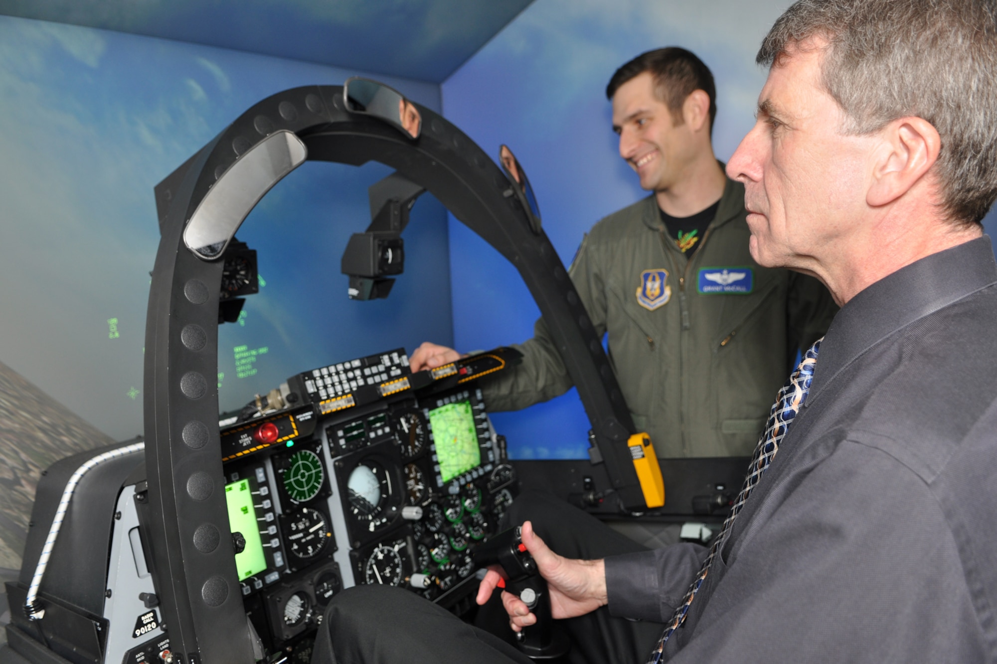 Phil Rose, managing editor, Professional Pilot magazine, flies a sortie in an A-10 simulator under the watchful eye of Capt. Grant McCall, standardization and evaluations liaison officer, 47th Fighter Squadron, at Barksdale Air Force Base, La., Dec. 10, 2010. Mr. Rose was at Barksdale gathering information for a story about the professional pilots of the 917th Wing for an upcoming issue of the Professional Pilot magazine to be published in early 2011. (U.S. Air Force photo/Tech. Sgt. Jeff Walston) 