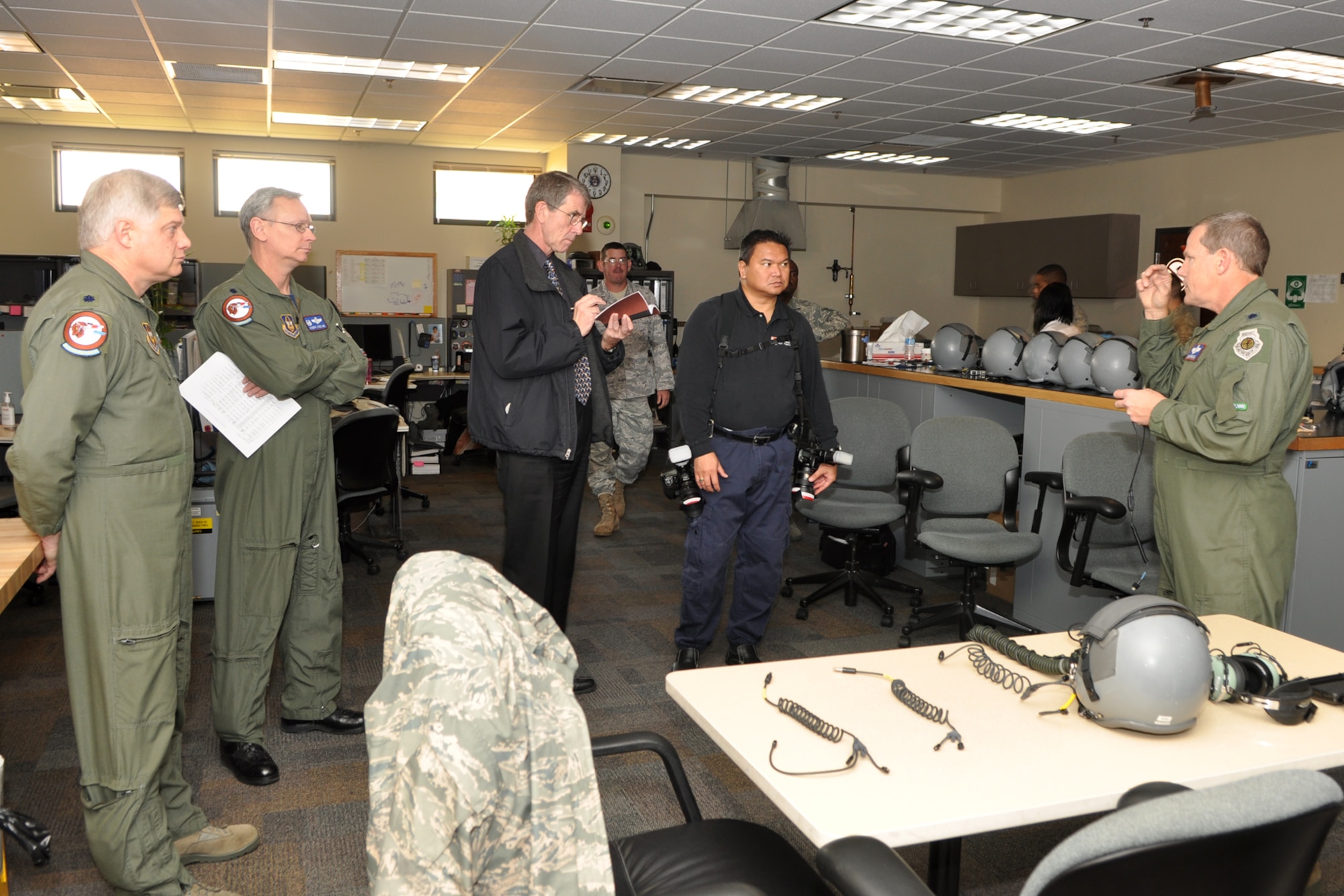 Lt. Col. Richard Holt, instructor electronic warfare officer, 93rd Bomb Squadron, Lt. Col. Joseph Jones, commander, 93rd BS, Phil Rose, managing editor, Professional Pilot magazine and Jack Sykes, art director, Professional Pilot magazine, listen to a briefing about ear plugs used by pilots in the cockpit, known as Attenuating Custom Communications Earpiece System, (ACCESS) by Lt. Col. Chris Rounds, standardization and evaluations branch chief, 917th Operations Group, at Barksdale Air Force Base, La., Dec. 10, 2010. Mr. Rose and Sykes were at Barksdale gathering information and photos for a story about the professional pilots of the 917th Wing for an issue of the Professional Pilot magazine to be published in early 2011. (U.S. Air Force photo/Tech. Sgt. Jeff Walston) 
