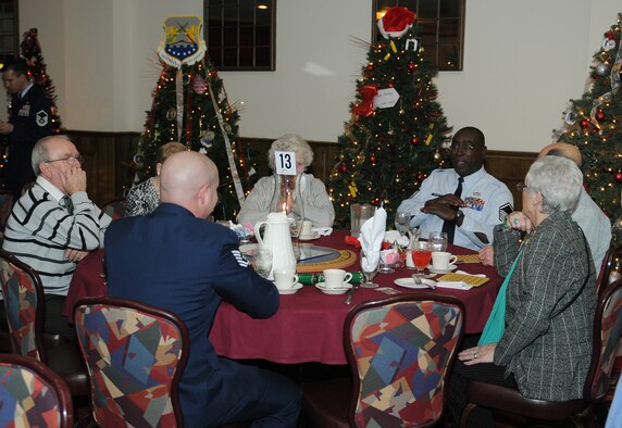 RAF MILDENHALL, England -- Servicemembers chat with local senior citizens during the 29th Annual Senior Citizens Luncheon here Dec. 16, 2010. This event was organized by the Top Three and sponsored by several base organizations to help maintain partnerships with the local communities. (U.S. Air Force photo/Senior Airman Tabitha M. Lee) 