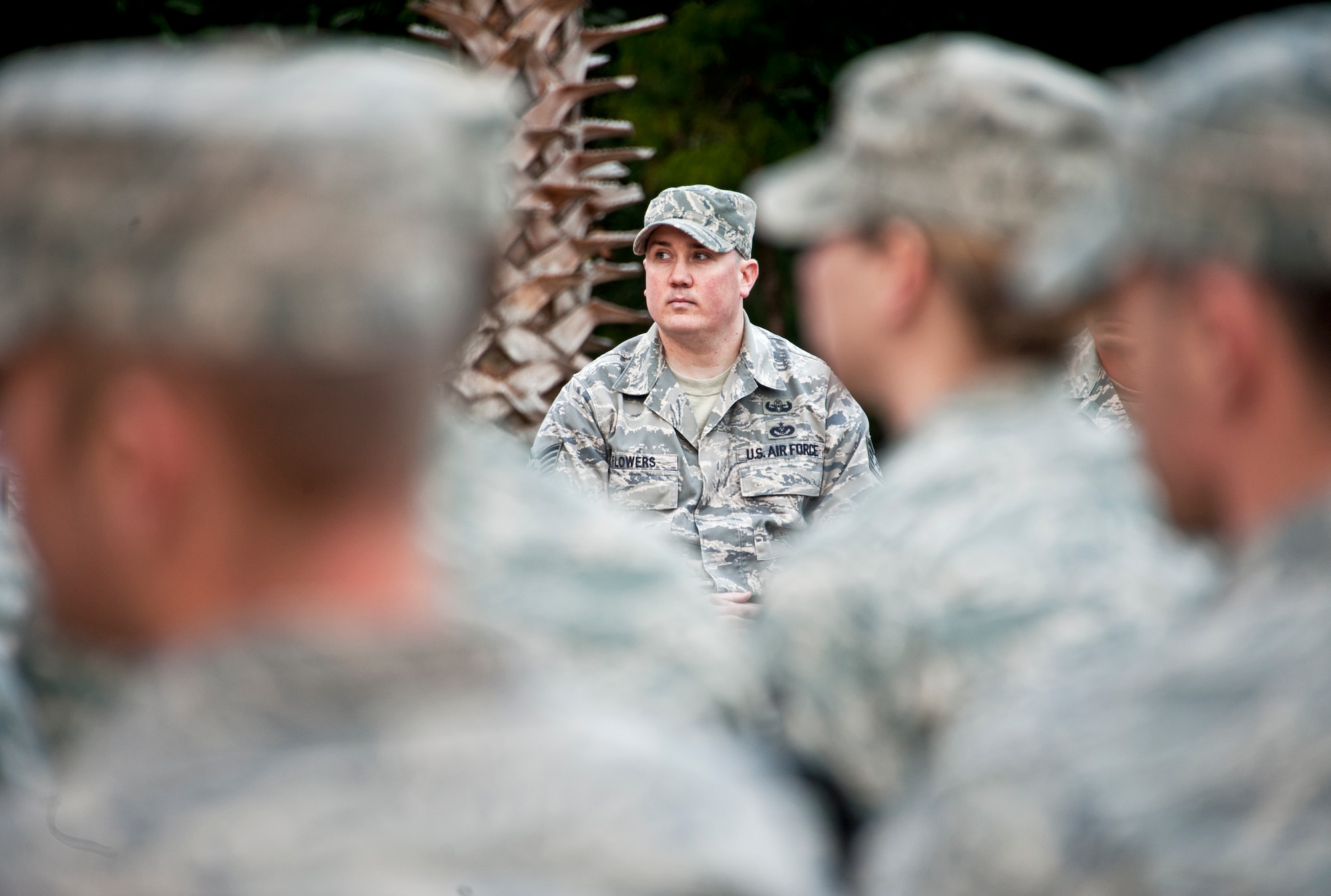 Staff Sgt. David Flowers, Naval Explosive Ordnance Disposal instructor, listens to his commander speak about his and Staff Sgt. Christopher Ferrell’s accomplishments during a ceremony in their honor Dec. 15.  The two NCOs were presented with a framed copy of their Air Force “Portraits of Courage” page by Brig. Gen. Darryl Burke, 82nd Training Wing commander.  The fifth edition of “Portraits of Courage” features 18 of the Air Force’s finest Airmen and their story of heroism.  To learn more about their heroic acts, go to http://www.af.mil/shared/media/document/AFD-101213-043.pdf.  (U.S. Air Force photo/Samuel King Jr.)