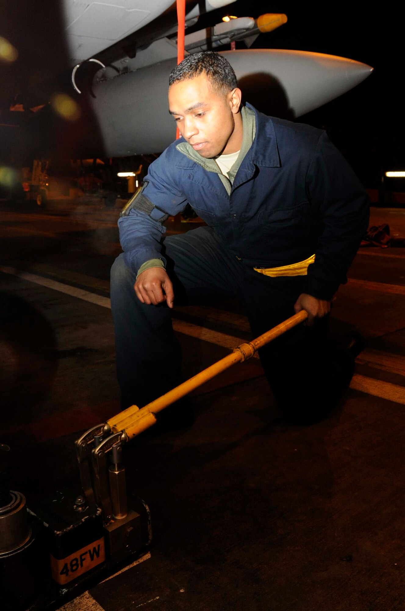 Airman 1st Class Bennie Hatch, 748th Aircraft Maintenance Squadron tactical aircraft crew chief, cranks up a aircraft tire Dec 15. Hatch was nominated for a Liberty Spotlight because he portrays the core value of ‘Service before Self’. (U.S. Air Force photo/Airman 1st Class Eboni Reams)