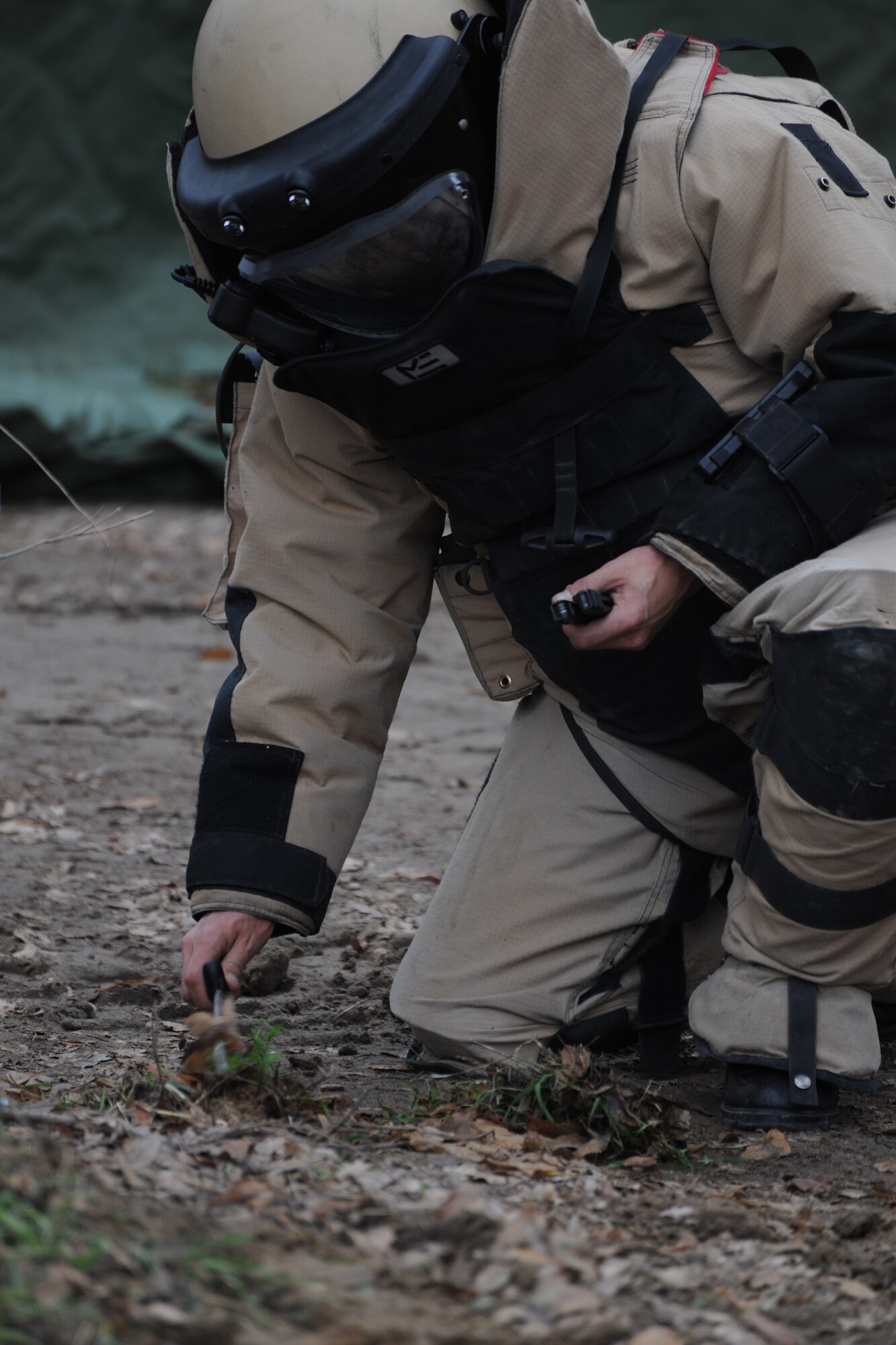 TRANSIT CENTER AT MANAS, Kyrgyzstan - A Kyrgyz Explosive Ordnance Disposal team member searches for improvised explosive devices as part of an exercise scenario used to share basic EOD operations during a U.S.-Kygyz military-to-military event held at the Transit Center at Manas Dec. 16.  This event increases overall awareness and sharpens EOD skills improving the ability to defend against extremist organizations who use unexploded ordnance and improvised explosive devices. (U.S. Air Force photo/Staff Sgt. Nathan Bevier)