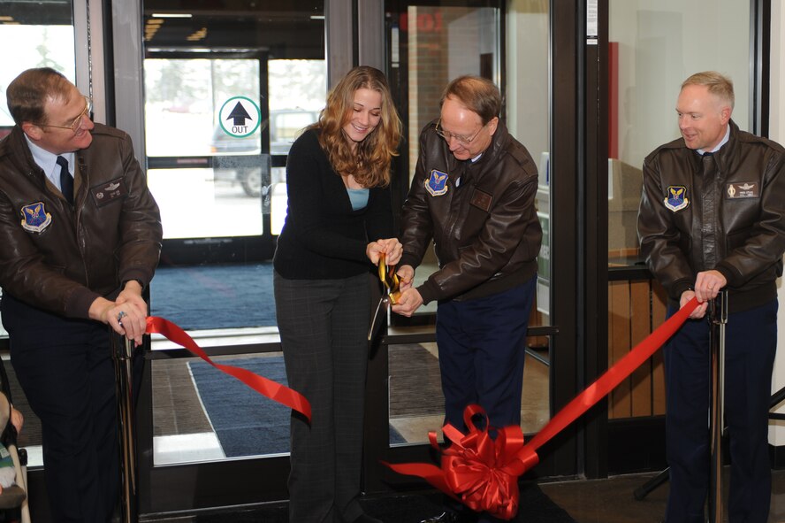 MINOT AIR FORCE BASE, N.D. – With a stiff wind and 9 degrees outside, Mrs. Katie Becker and Lt. Gen. Frank Klotz cut the ceremonial ribbon, opening a breezeway connecting Minot’s Base Exchange and Commissary buildings here Dec. 13. as Col. Doug Cox, 5th Bomb Wing commander, and Col. Fred Stoss, 91st Missile Wing commander, look on.  The enclosed breezeway provides a safe and sheltered passage for Airmen, family members and retirees between the two busiest buildings on base.  Mrs. Becker is the wife of deployed Staff Sgt. Dustin Becker, 5th Aircraft Maintenance Squadron weapons loader.  General Klotz is commander, Air Force Global Strike Command. (U.S. Air Force photo by Airman 1st Class Aaron-Forrest Wainwright)